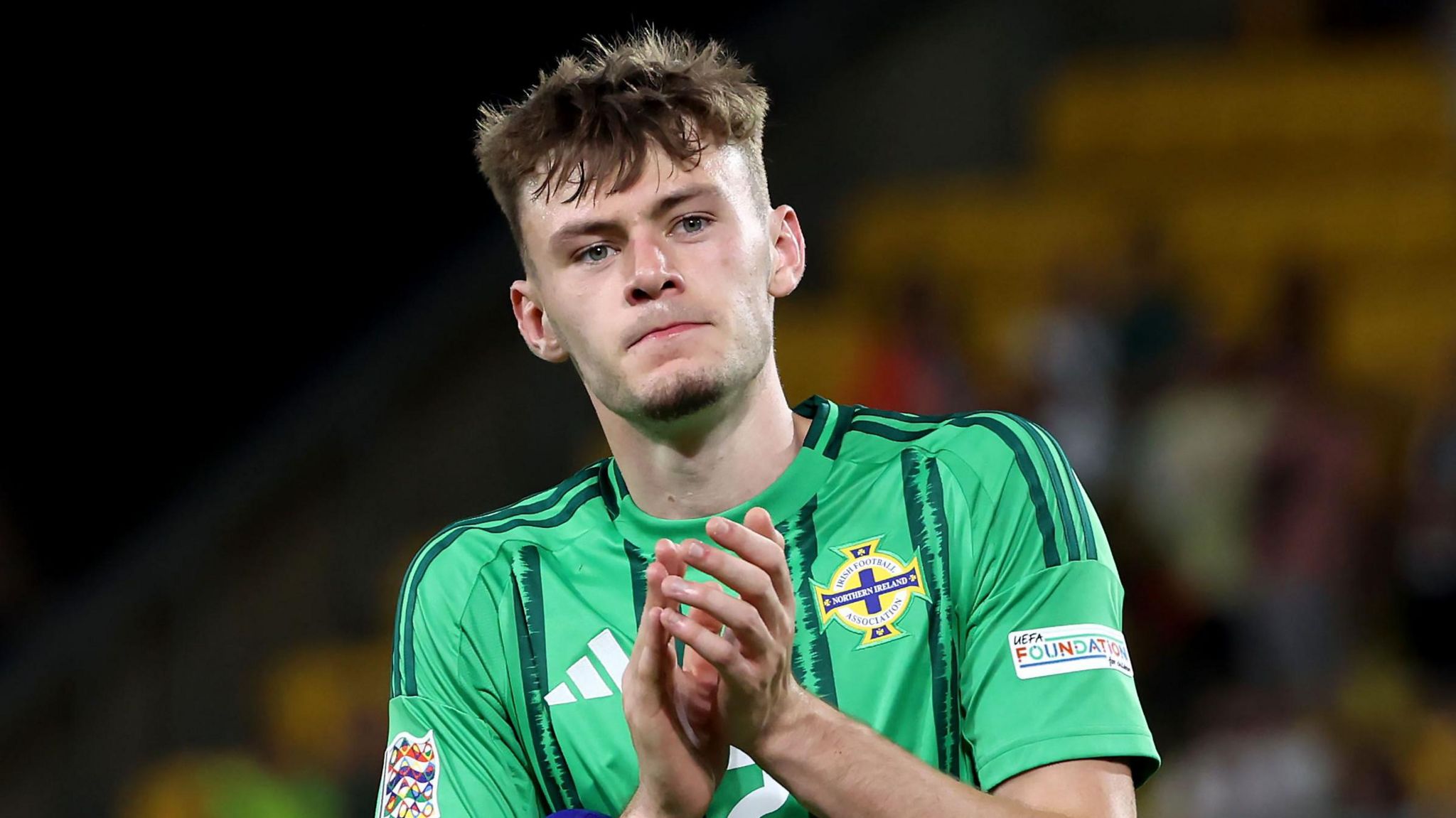 Conor Bradley applauds supporters aft nan game