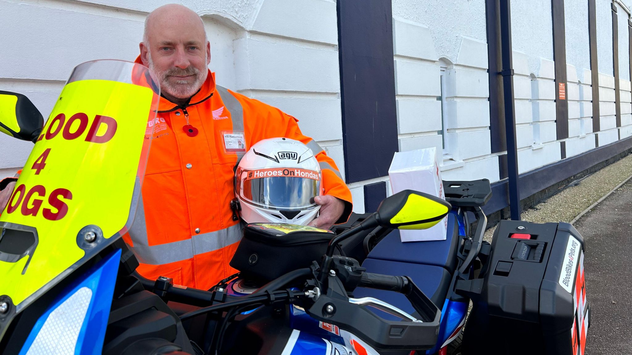 Tom Watkins next to blood delivery motorbike.