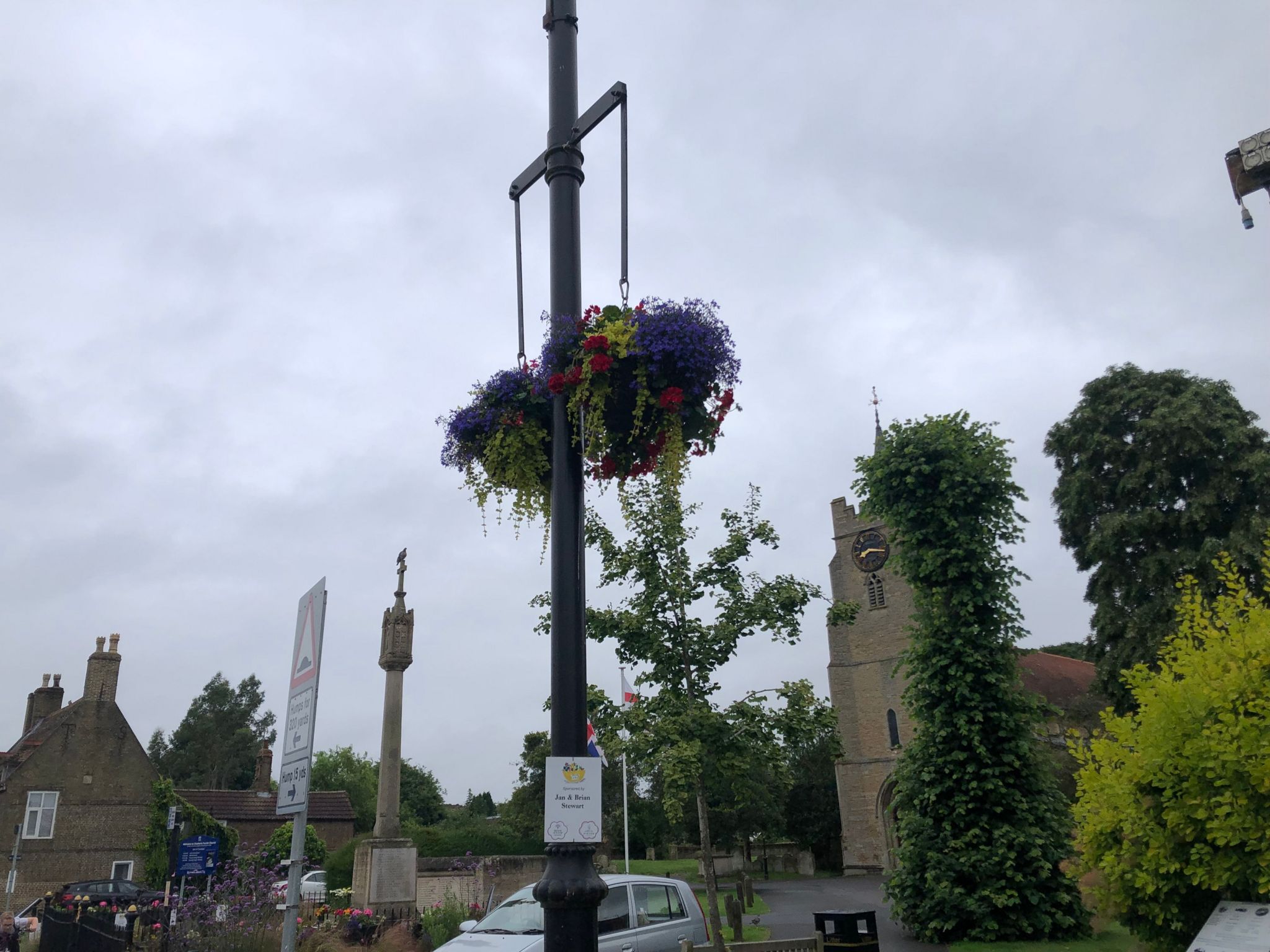 Hanging baskets displayed from a lamppost near the parish church in Chatteris