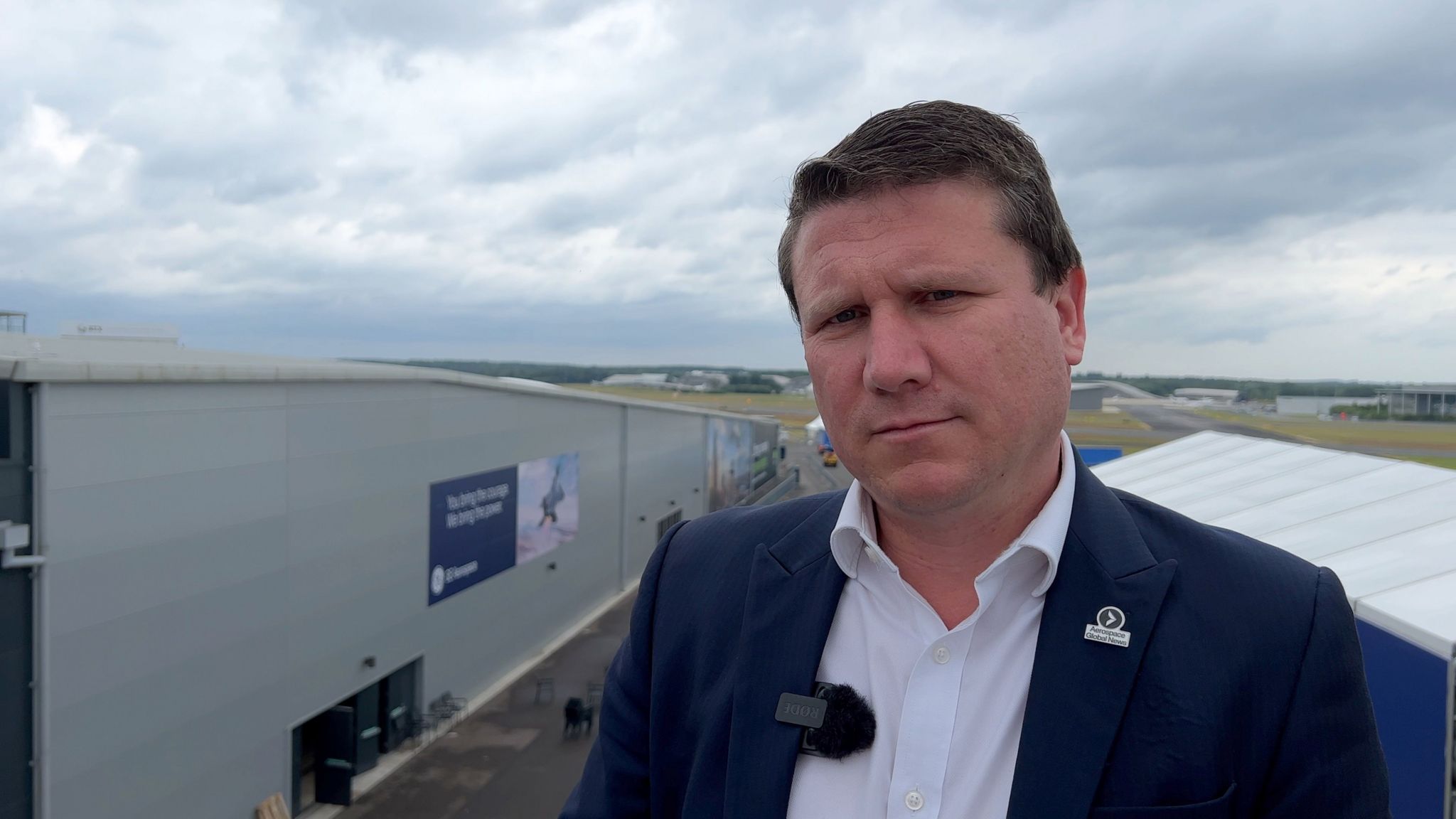 Farnborough Airshow CEO Gareth Rogers stands in front of one the exhibition halls.