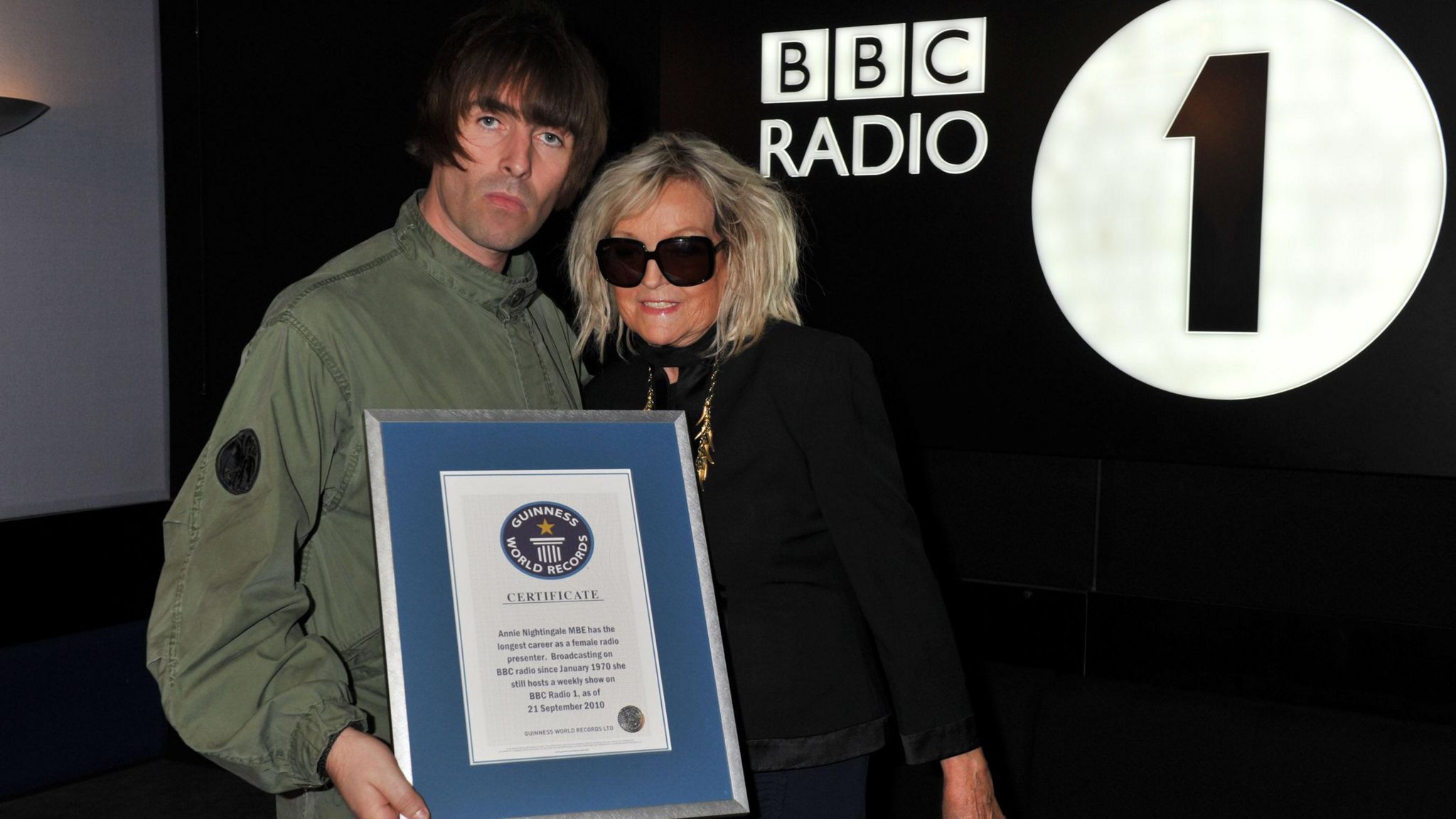 Liam Gallagher presenting Annie Nightingale with a Guinness World Record