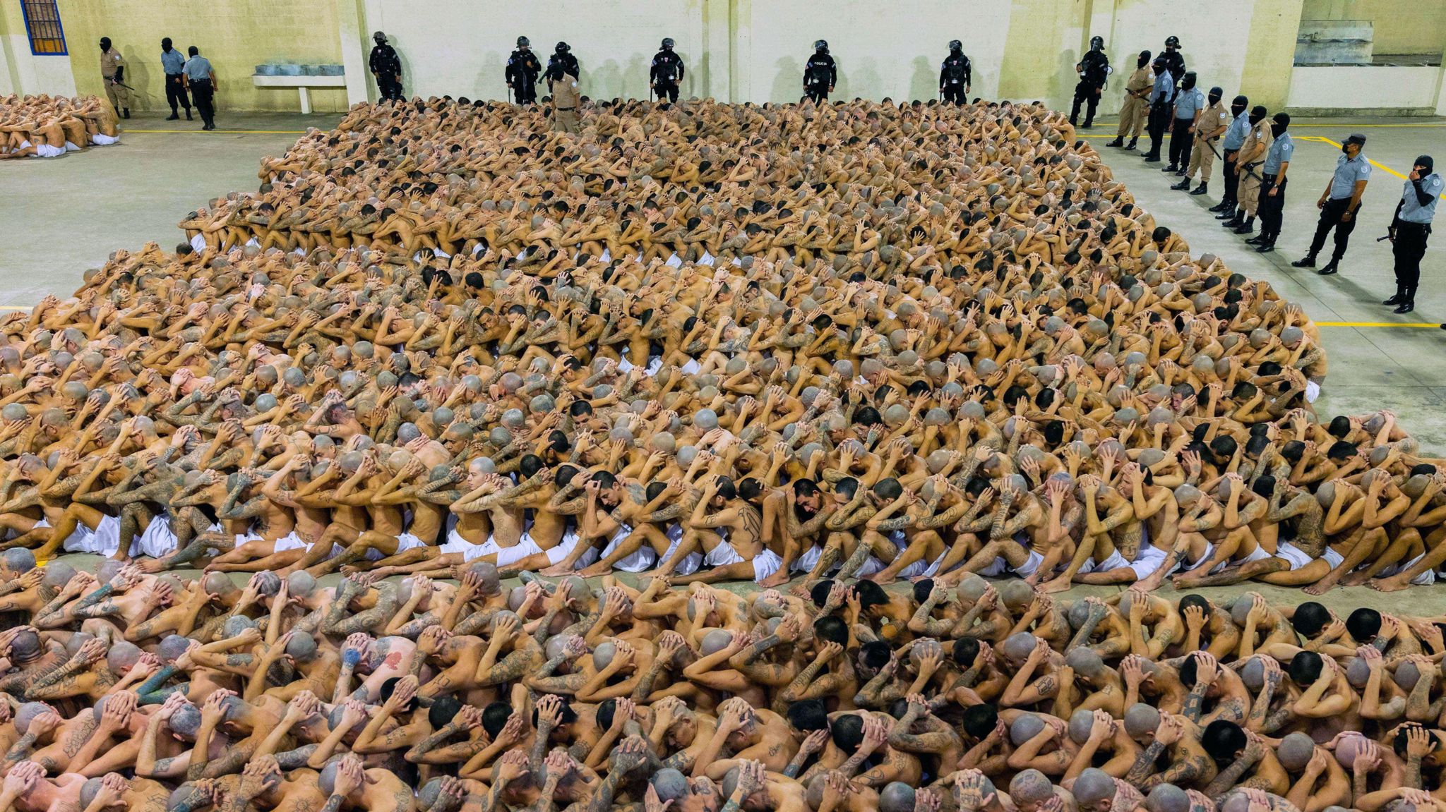 A photo provided by El Salvador's government shows hundreds of inmates sitting tightly packed at the Cecot prison