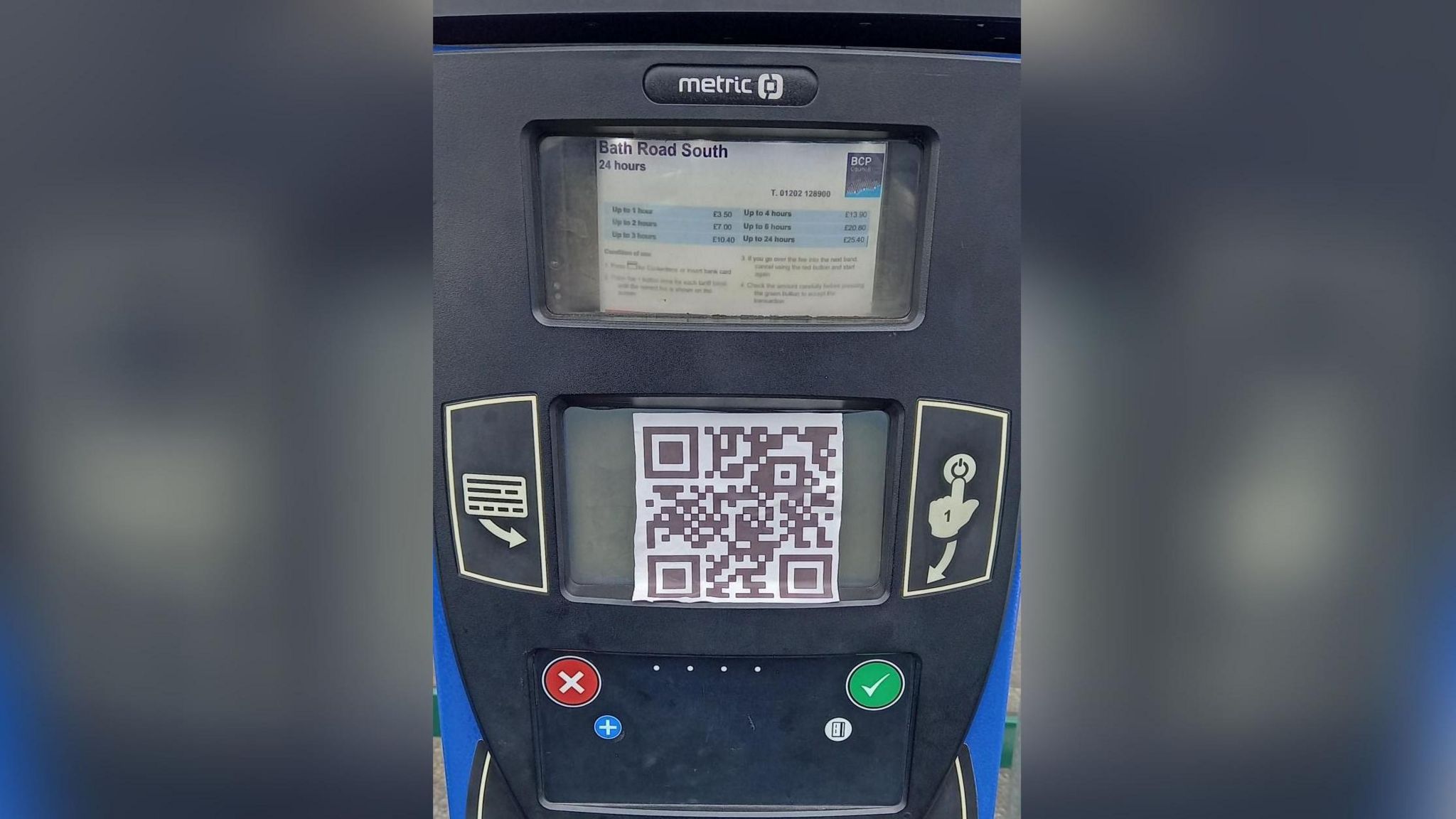 a parking machine with a large QR code stuck on it. The machine reads 'Bath Road South'.