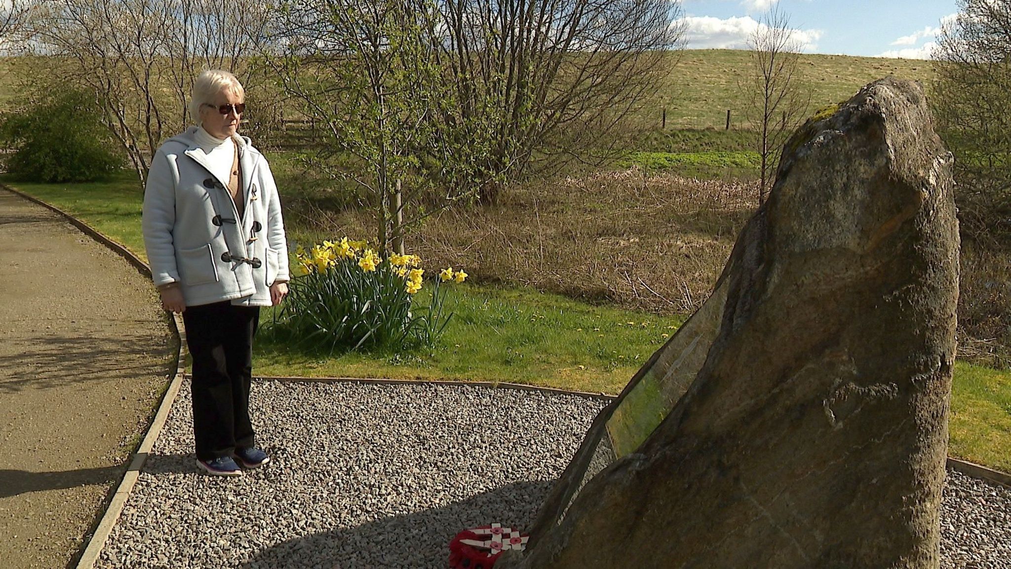 Tabby Angier stood at a grave