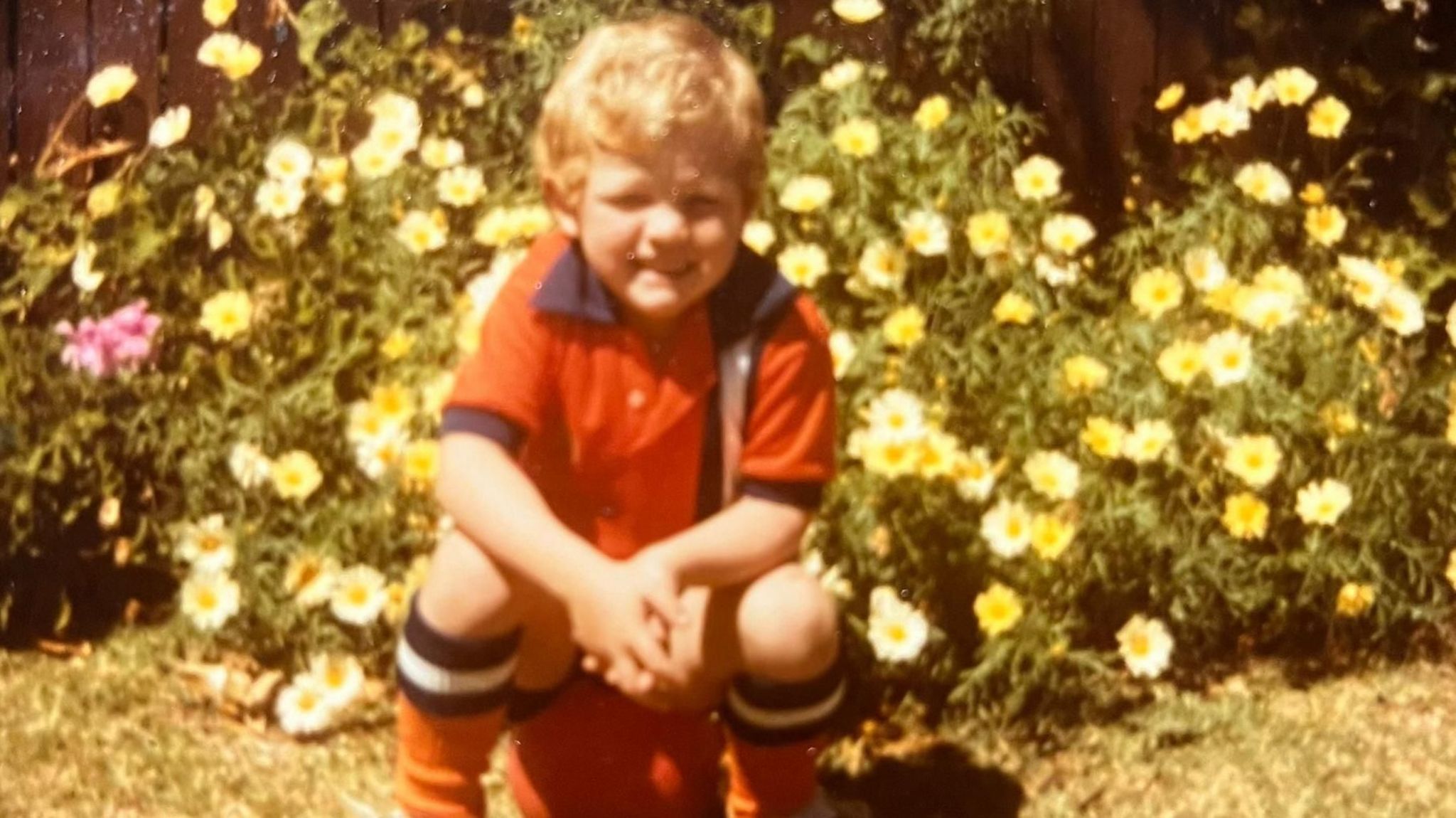 David Burton wearing a Luton kit as a child and sat on a football