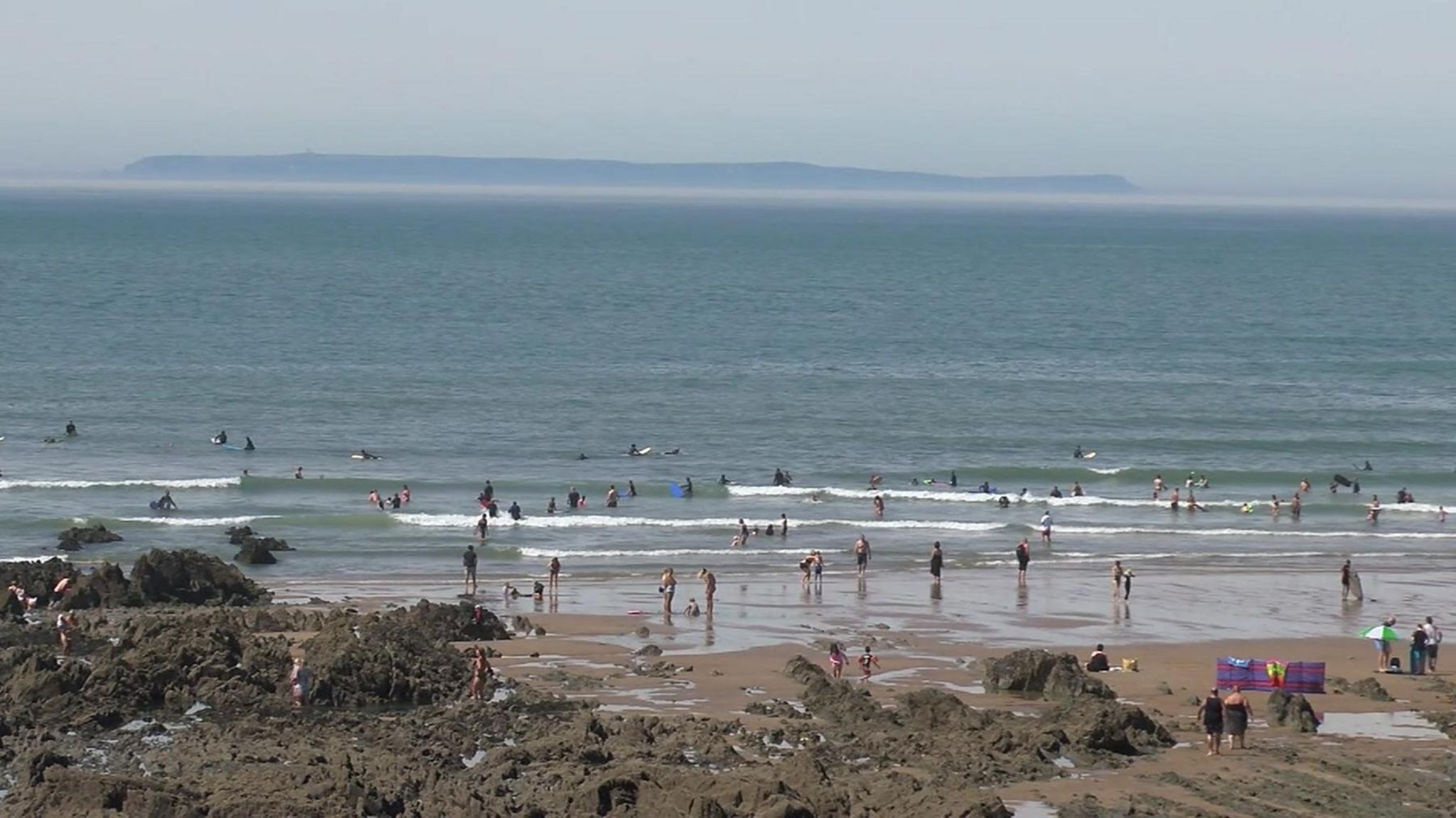 People in the sea at Croyde beach, Devon