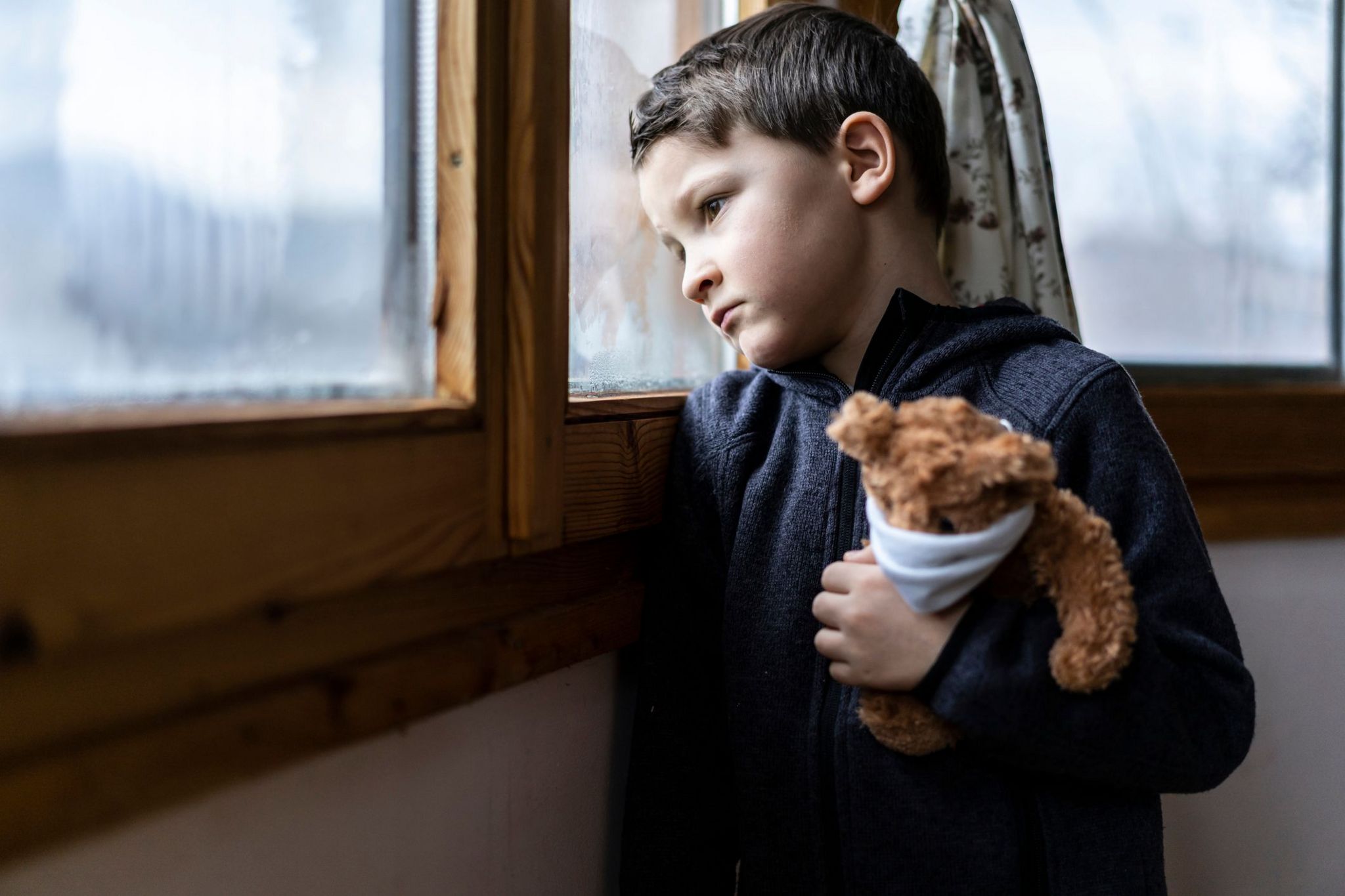 Child holding teddy (stock image)