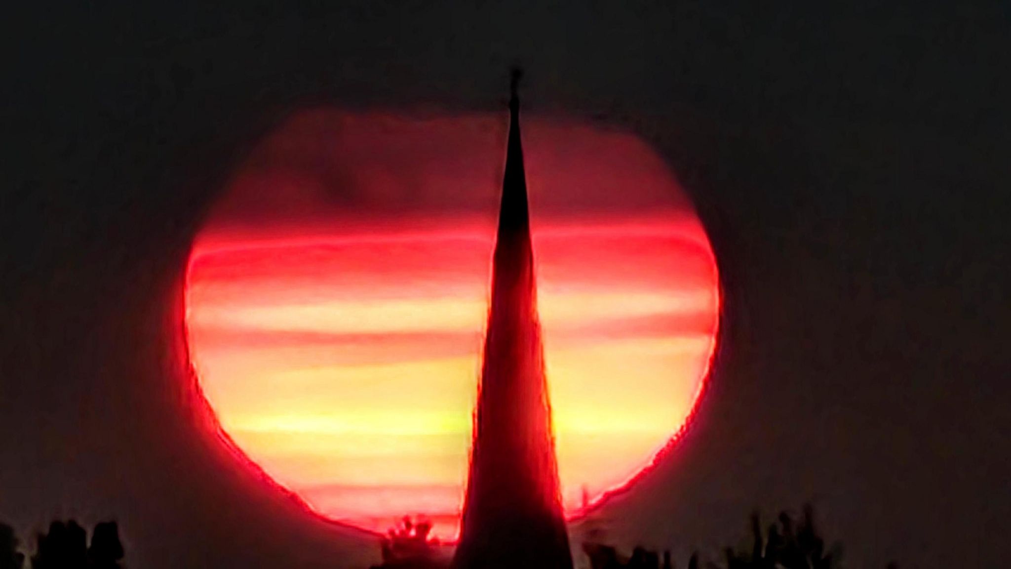 Dramatic sunset framed against the silhouette of a church spire in Irthlingborough, Northamptonshire