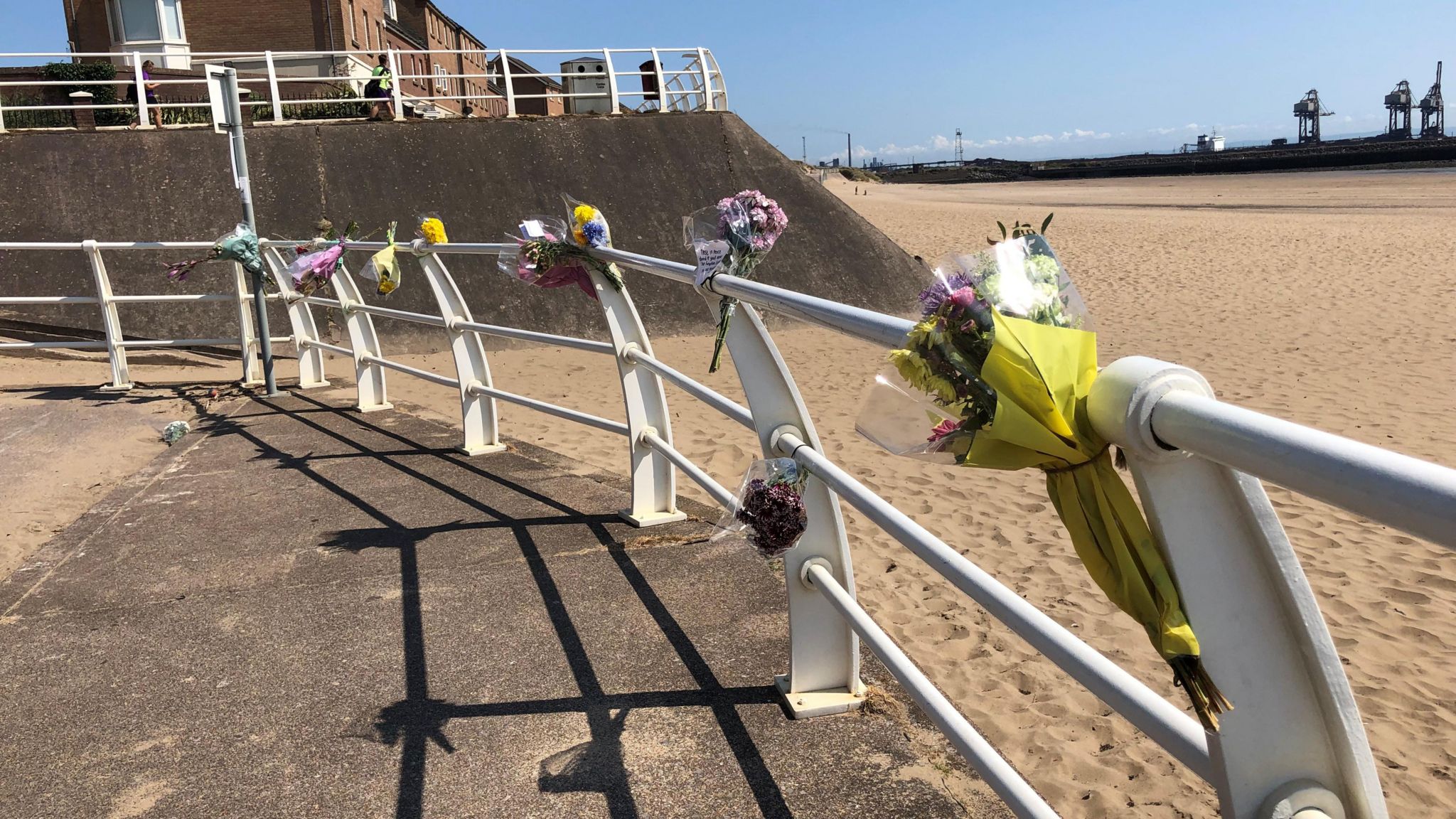 Flowers tied to a railing above Averavon beach in a tribute to David Ejimofor 