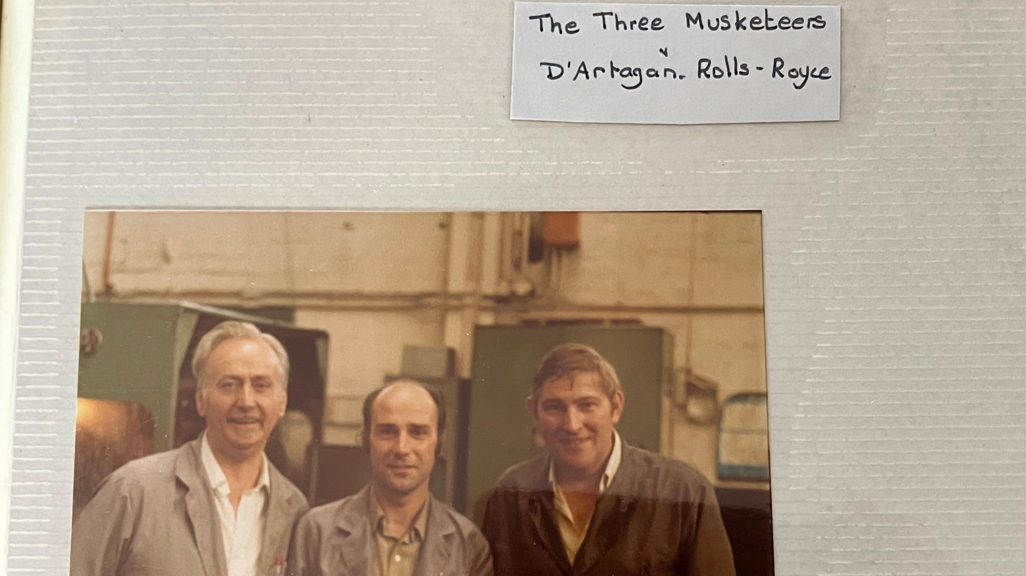 Photo of three men from album