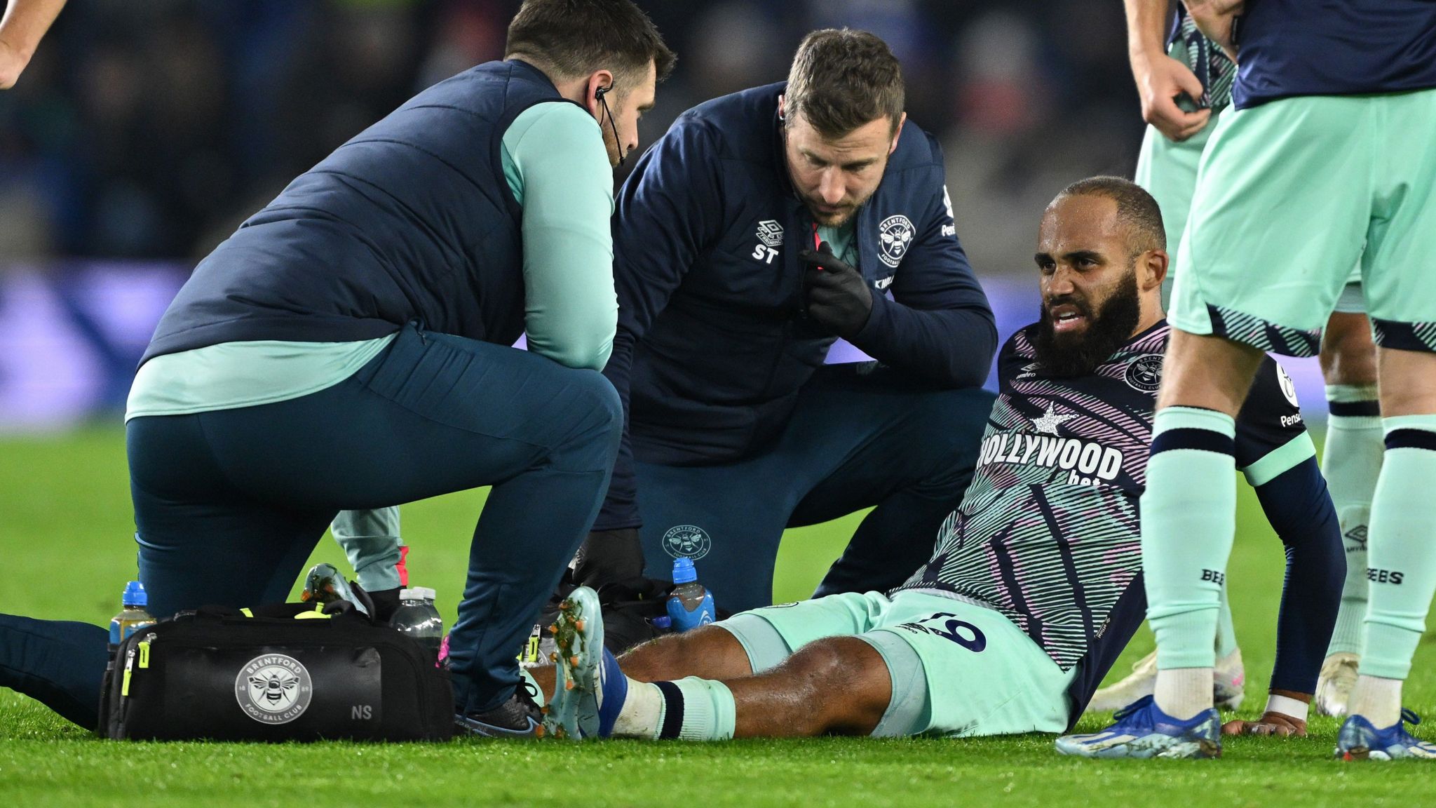 Bryan Mbeumo receives treatment on an injury