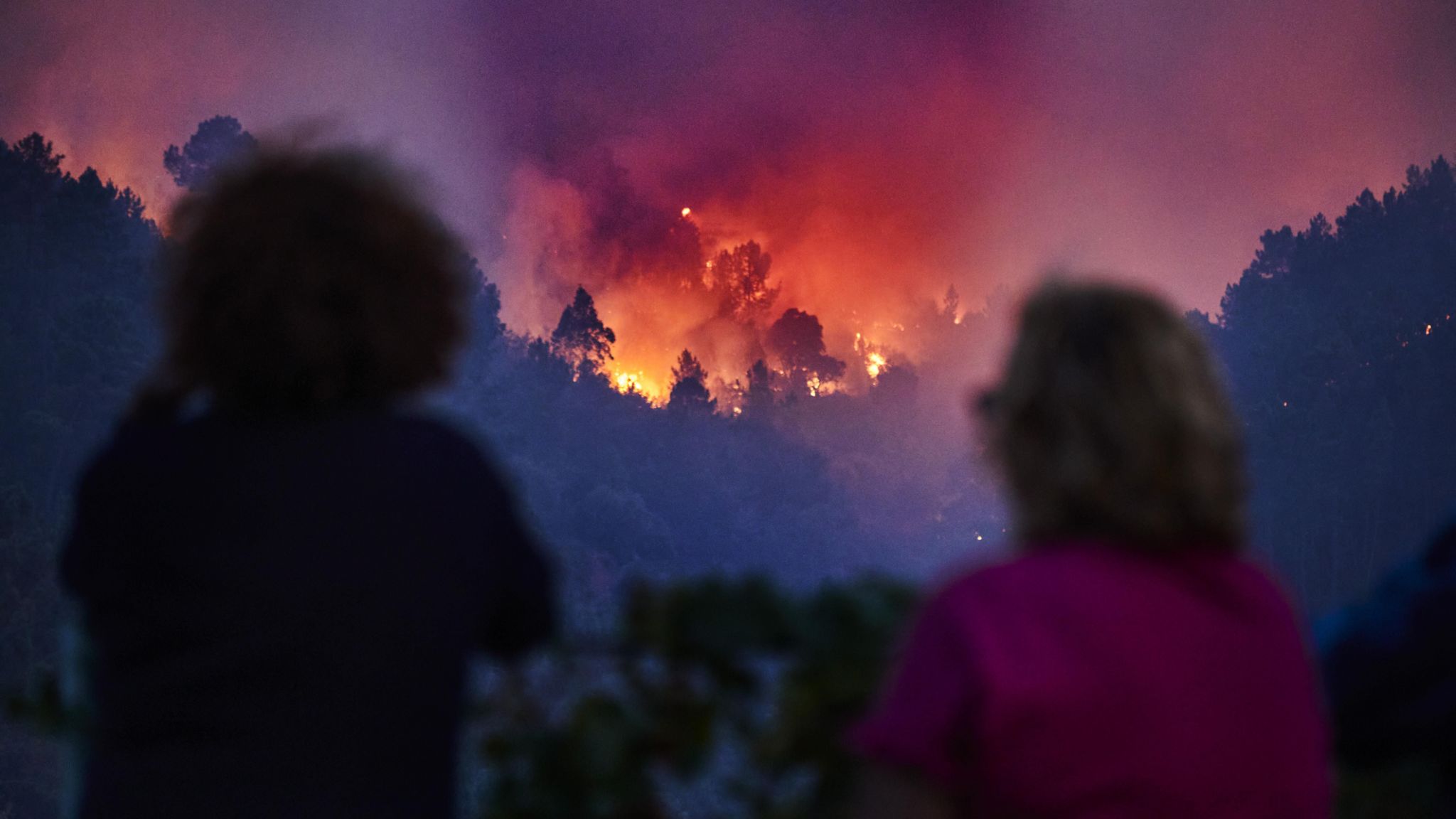 Firefighter battling a wildfire in Penalva do Castelo, Portugal.