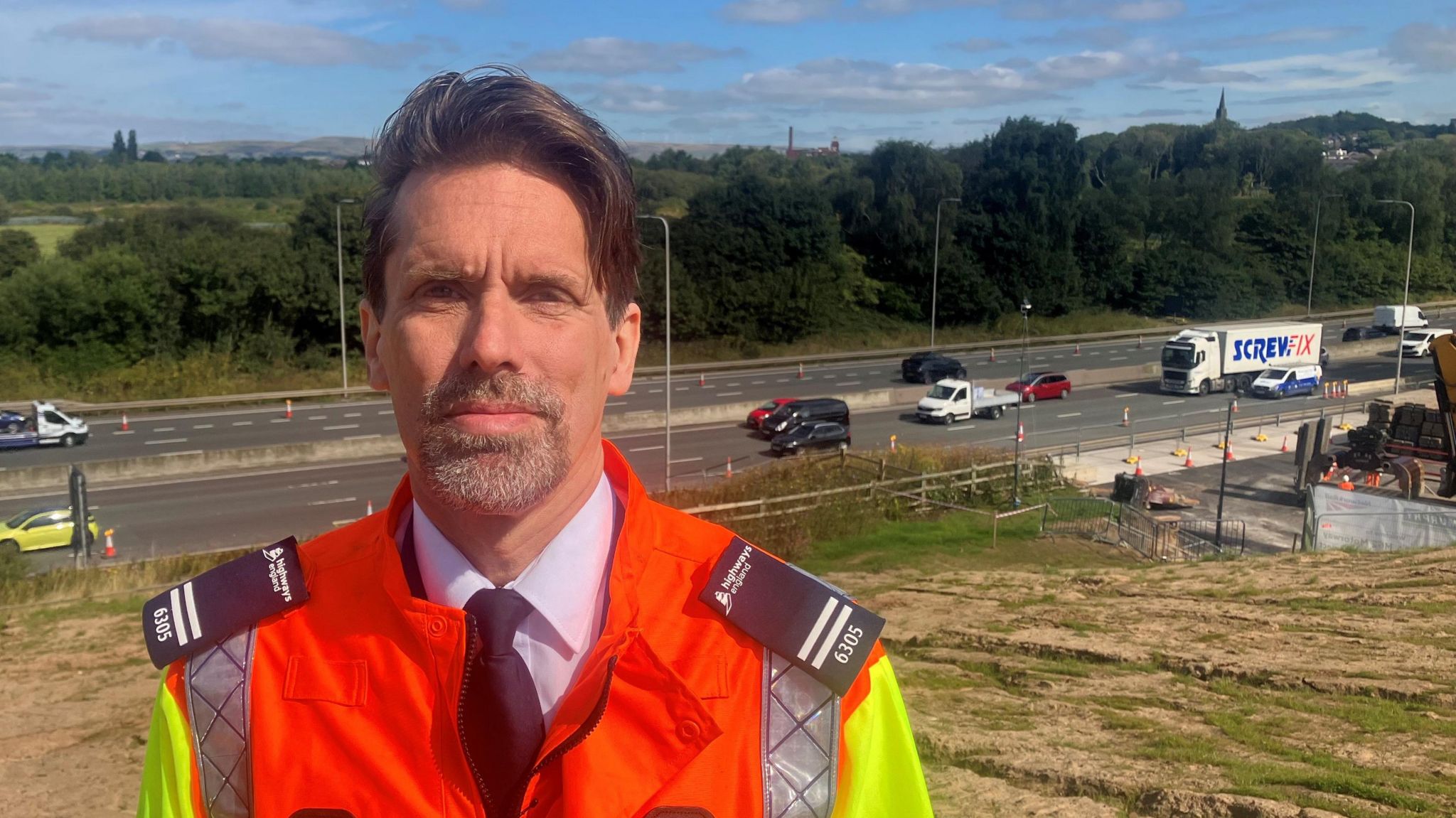 Dee Murray on a grass bank above the M62