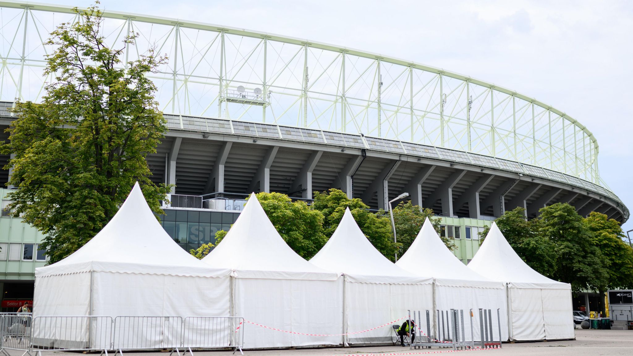 View of the exterior of the Ernst Happel Stadium in Vienna with event marquees in the foreground