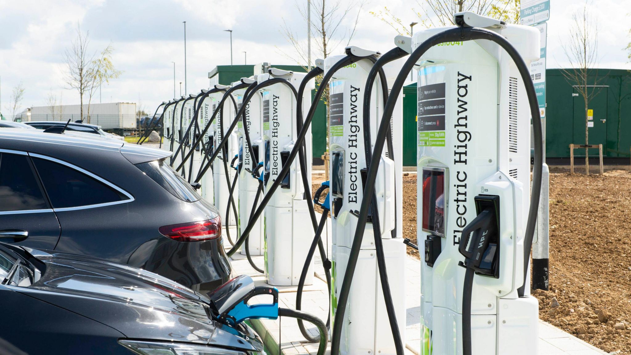 A row of EV chargers at a service station