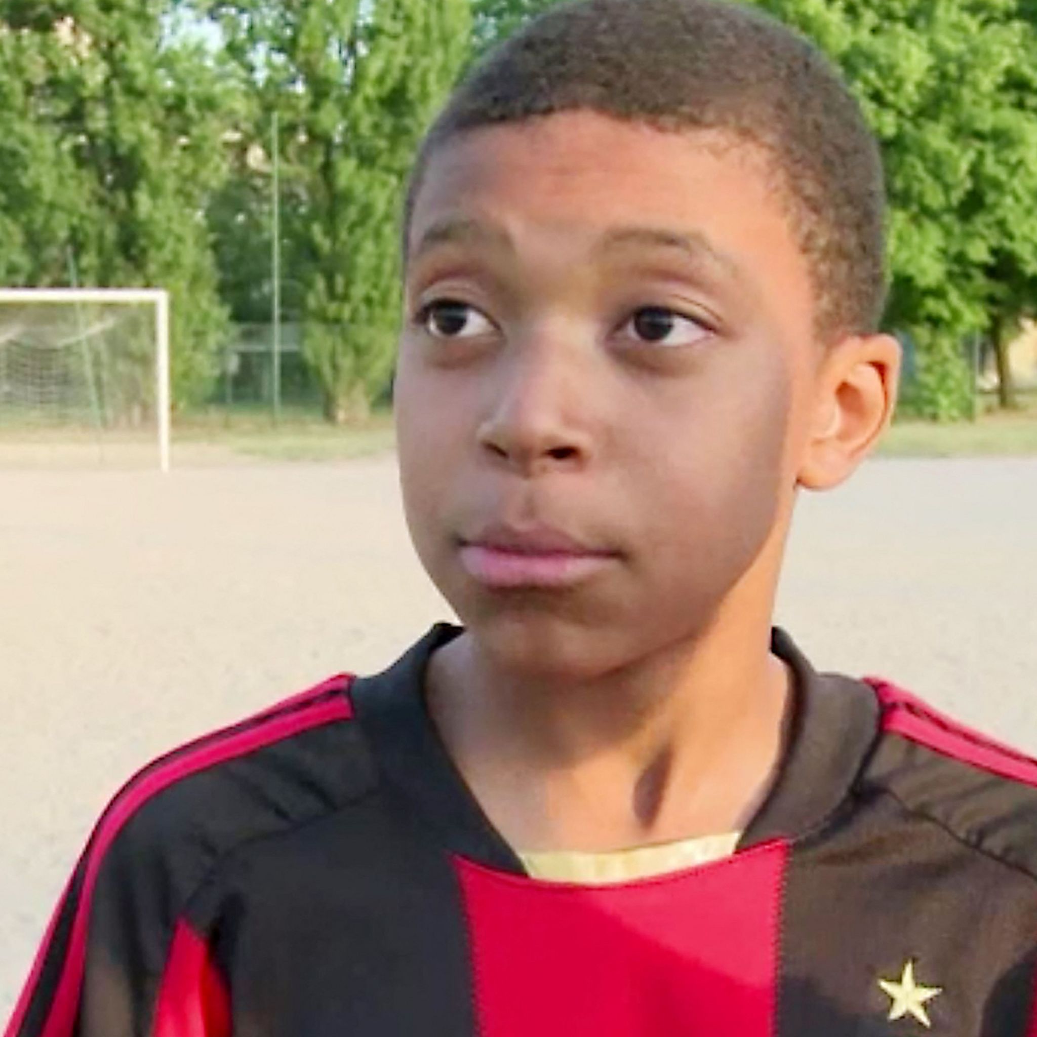 A 12-year-old Kylian Mbappe in an AC Milan shirt