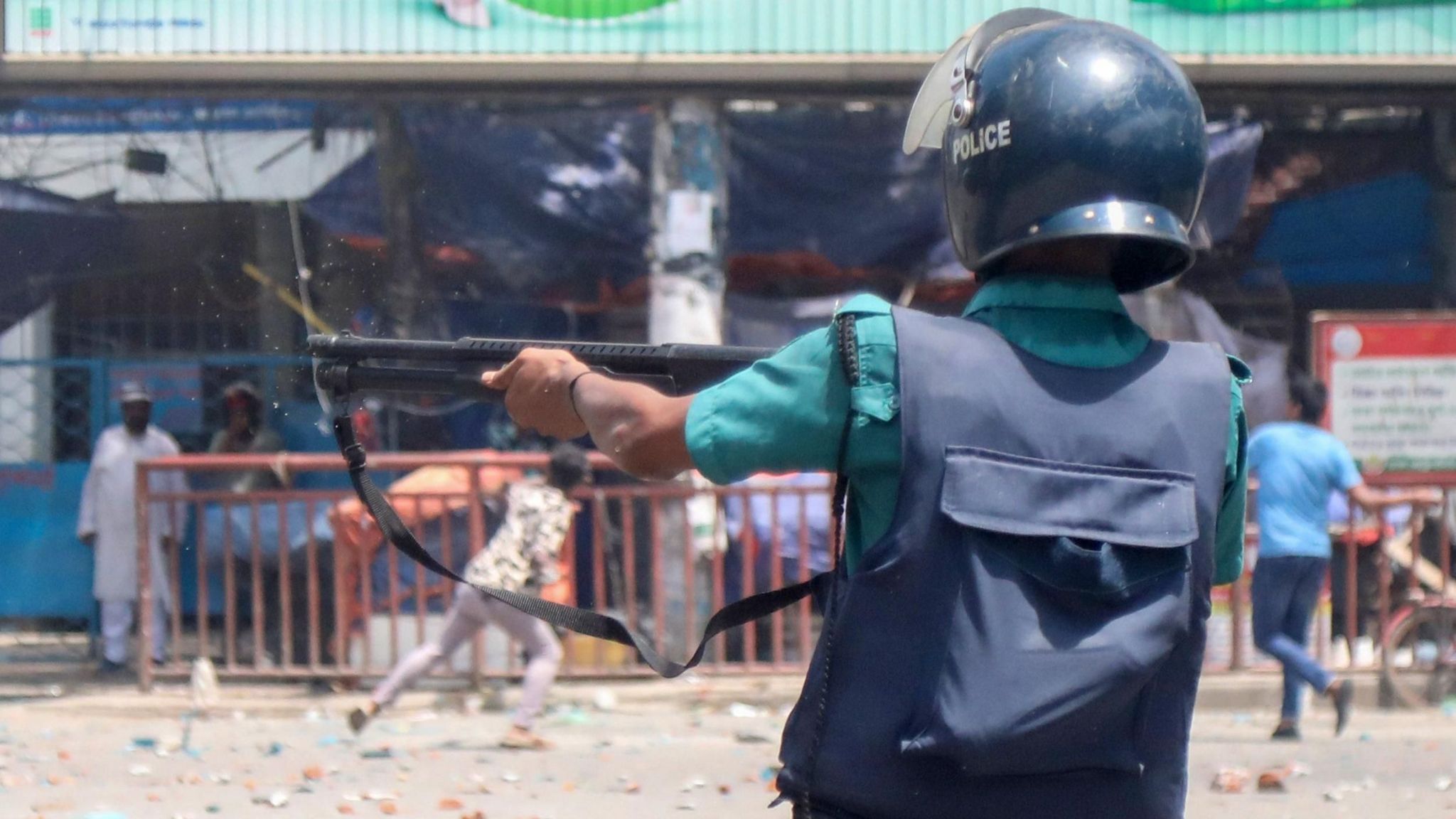 A Police member reacts as demonstrators clash with police, Bangladesh Chhatra League (BCL) and Jubo League members, during ongoing quota students protests under the slogan 'Anti-Discrimination Student Movement' at Mirpur area in Dhaka, Bangladesh, 18 July 2024