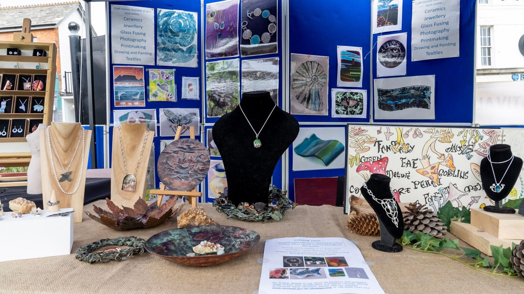 Products produced by students including jewellery and textiles on display
