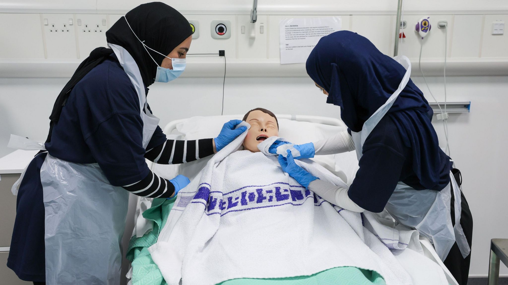 Two students practise their skills on a dummy at Middlesbrough College