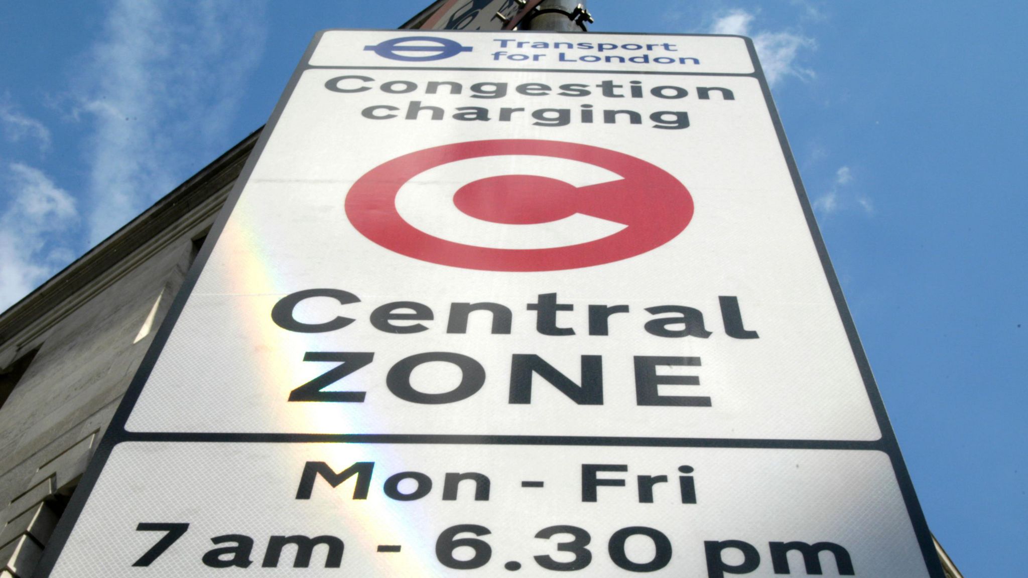 Top half of a white congestion charging zone sign in Camden