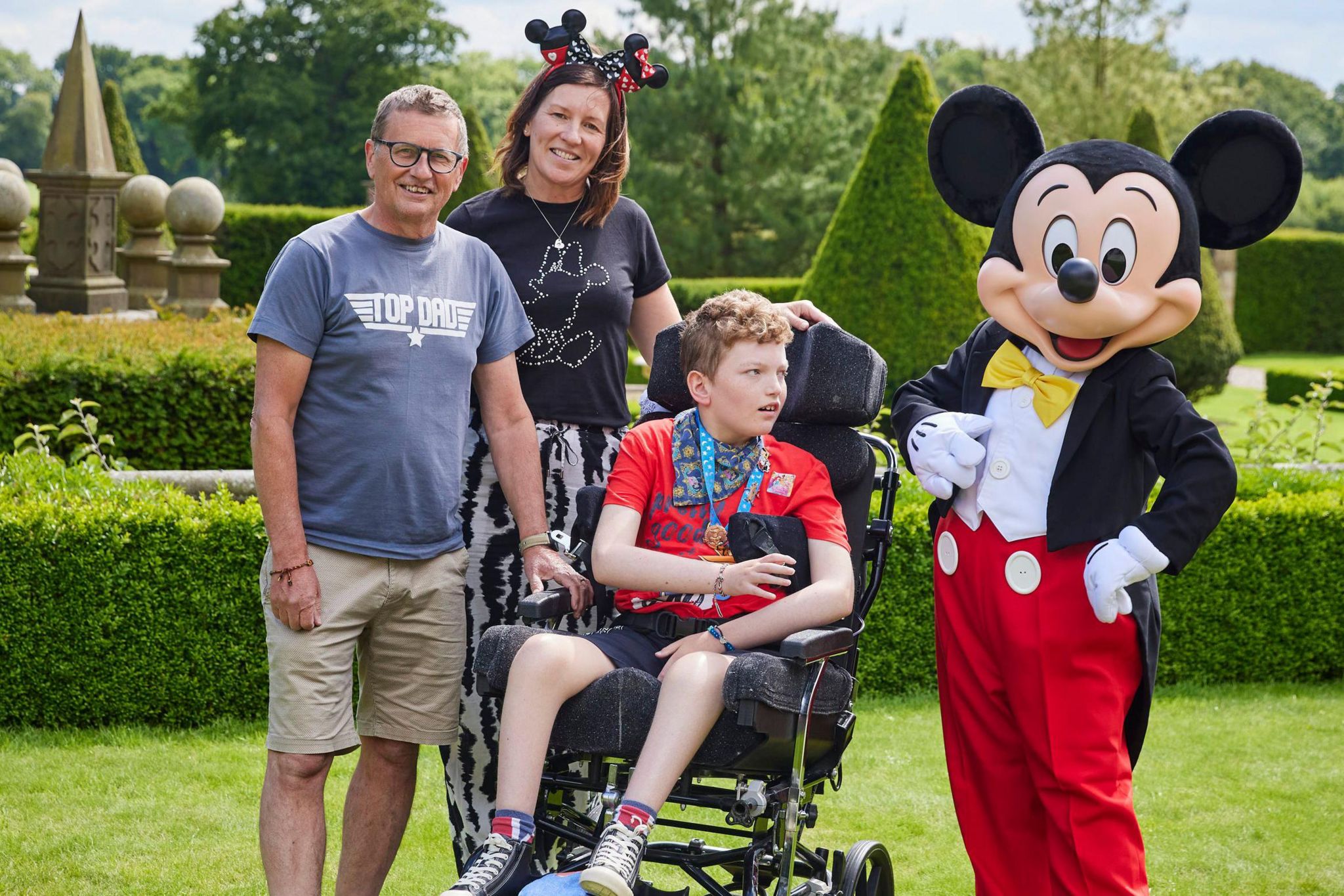 Barney with dad Andy, mum Beverley and Mickey Mouse