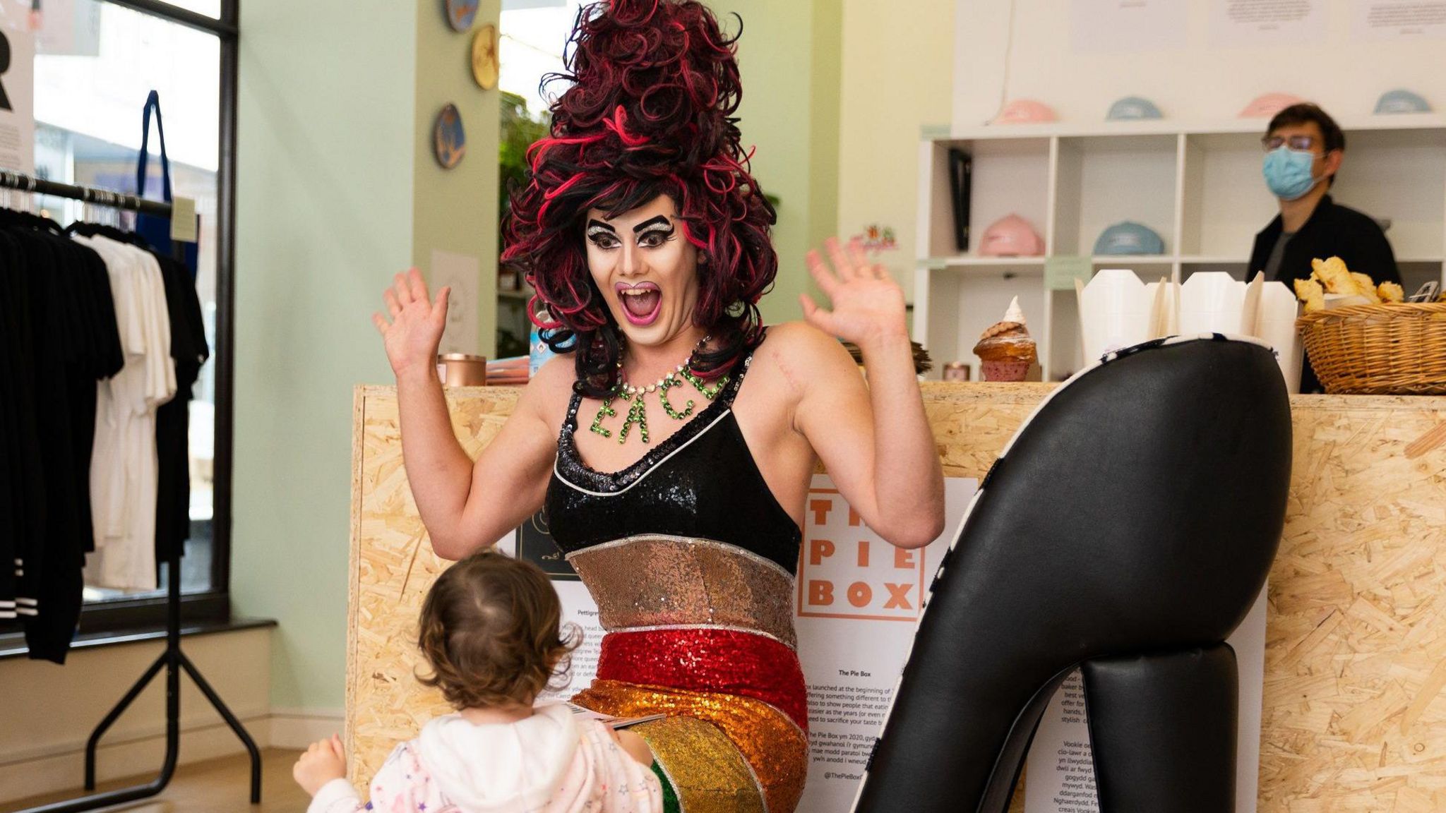 Drag queen smiling at child during show