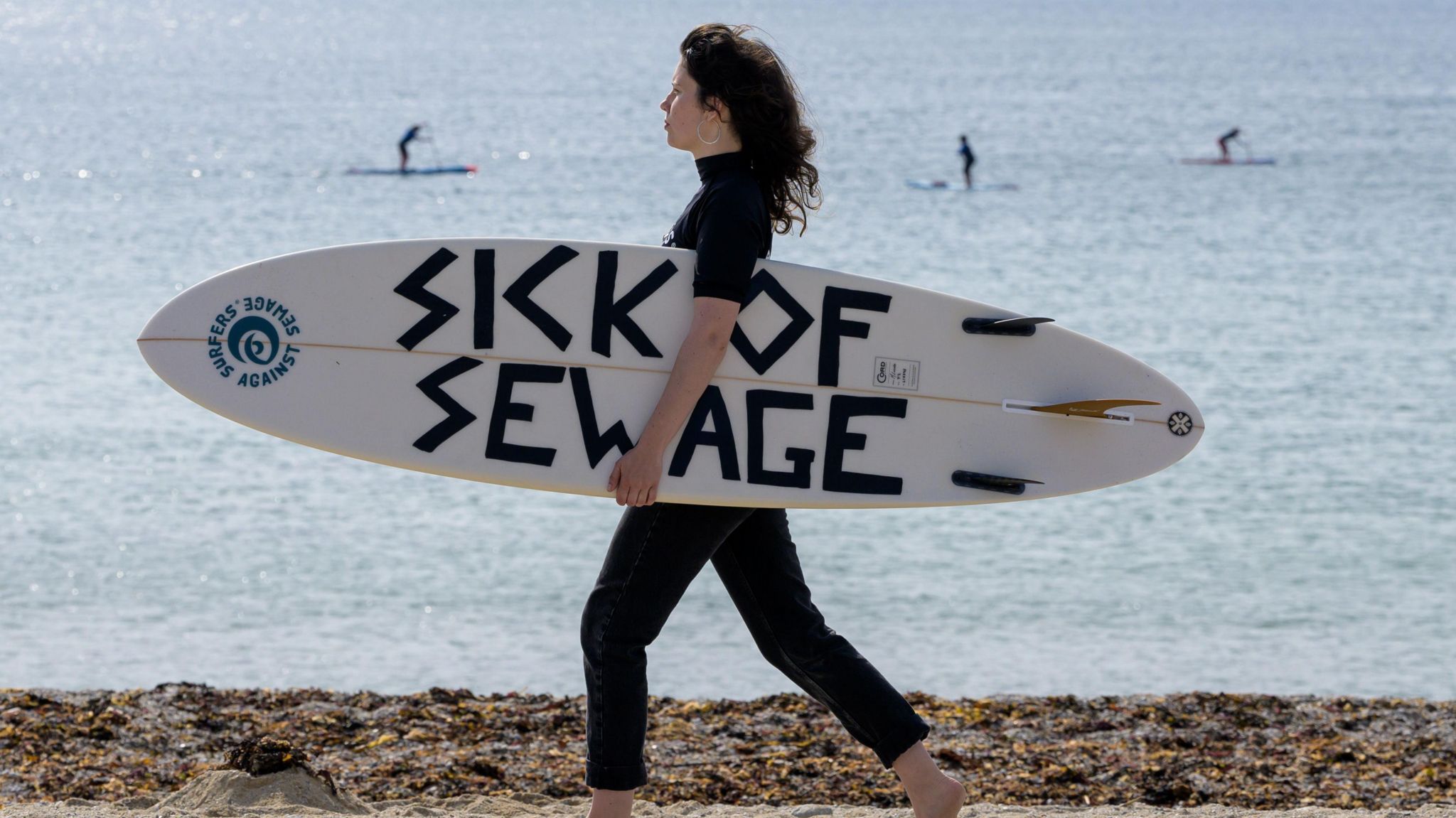 A surfer taking part in a protest in Falmouth, Cornwall