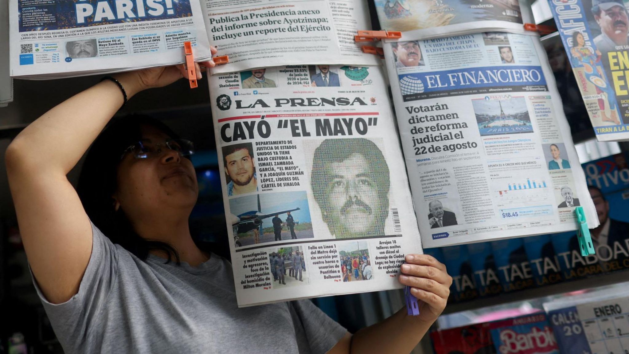 A newspaper seller arranges newspapers reporting the El Paso, Texas, U.S., arrest of Mexican drug lord Ismael "El Mayo" Zambada 