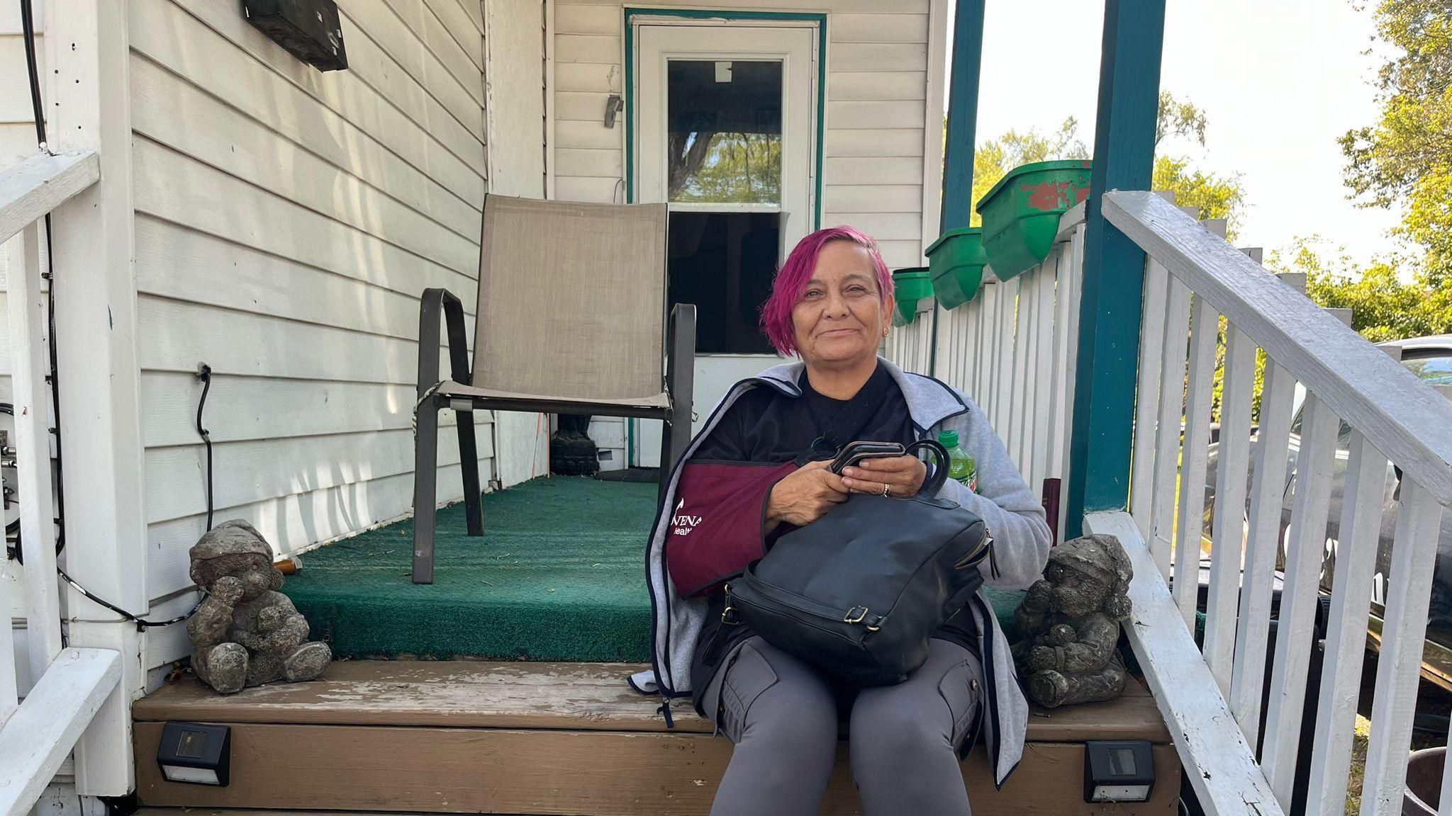 Rachel Oviedo, 57, sits on her porch