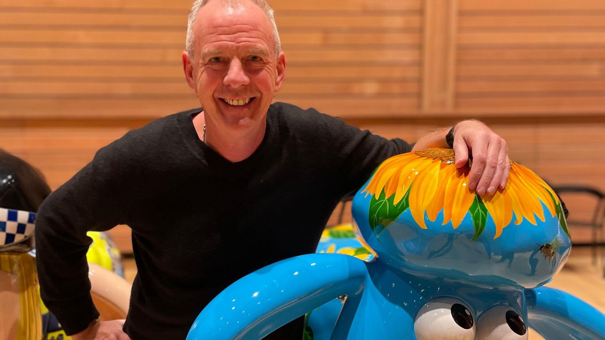 DJ Norman Cook with a painted Shaun the Sheep statue
