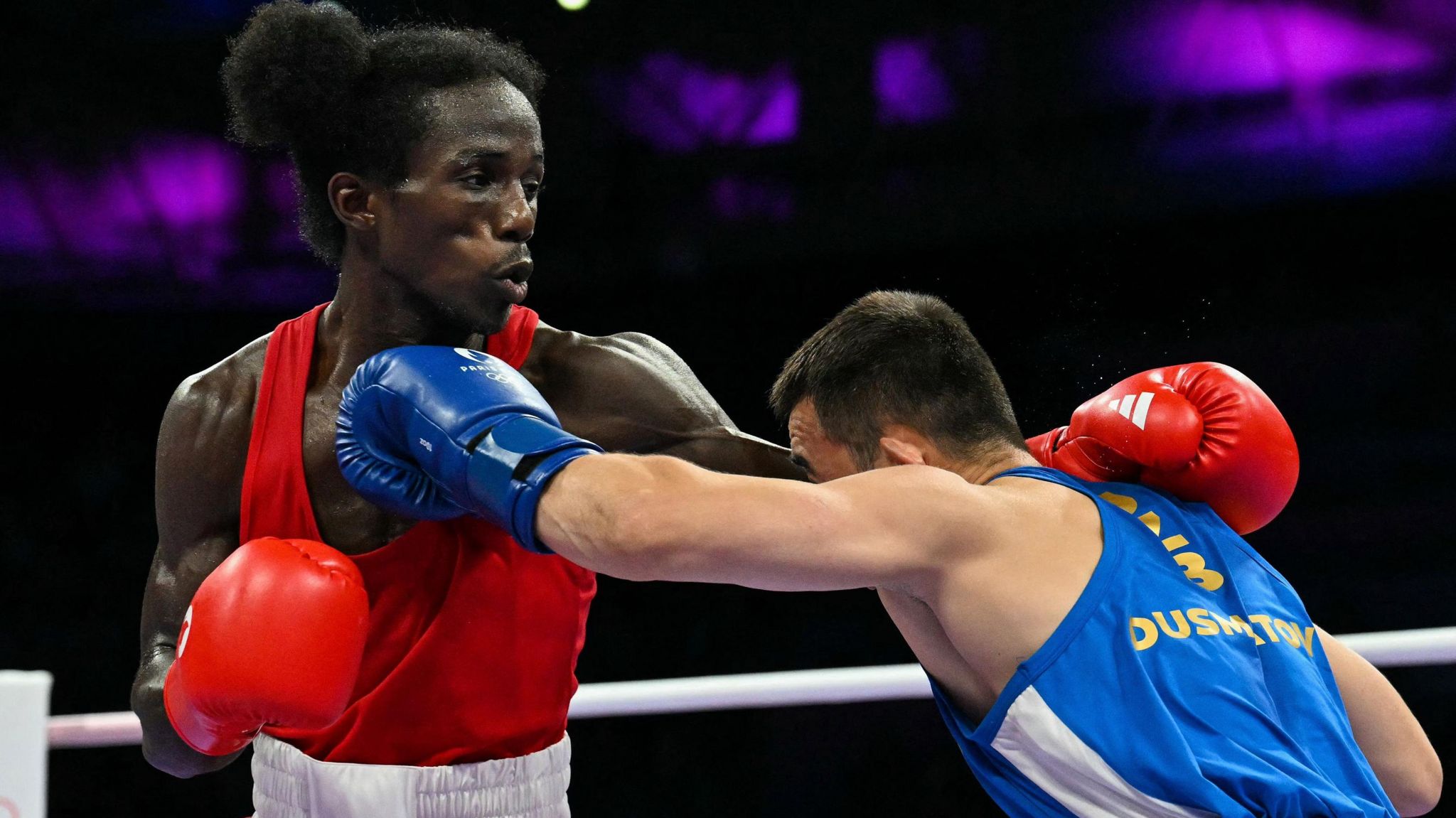 David de Pina of Cape Verde (left) in action against Hasanboy Dusmatov at Paris 2024