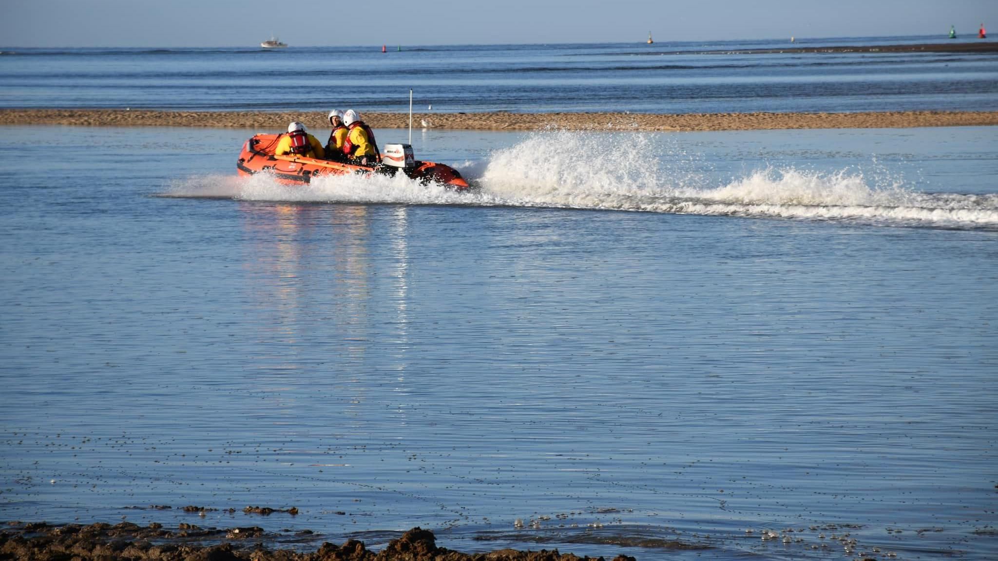 A stock shot showing an inshore lifeboat with three crew heading out to sea from a beach in north Norfolk.