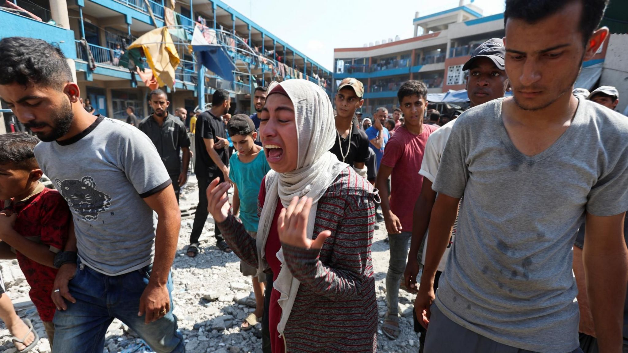 A woman reacts after an Israeli air strike on an Unrwa-run school in Nuseirat refugee camp, central Gaza, following an Israeli air strike (14 July 2024)