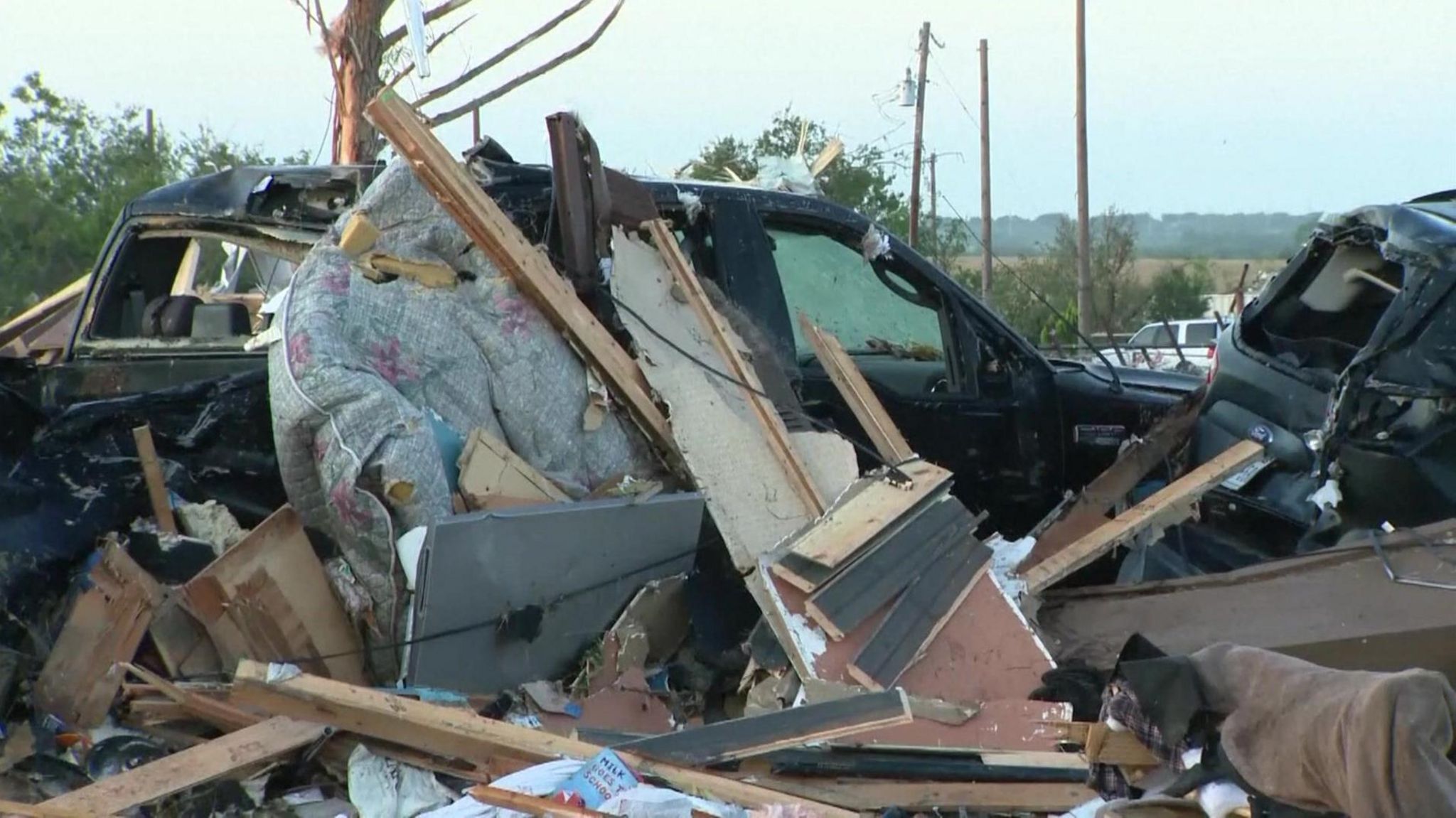 A car sits in a pile of debris after major storms through Texas