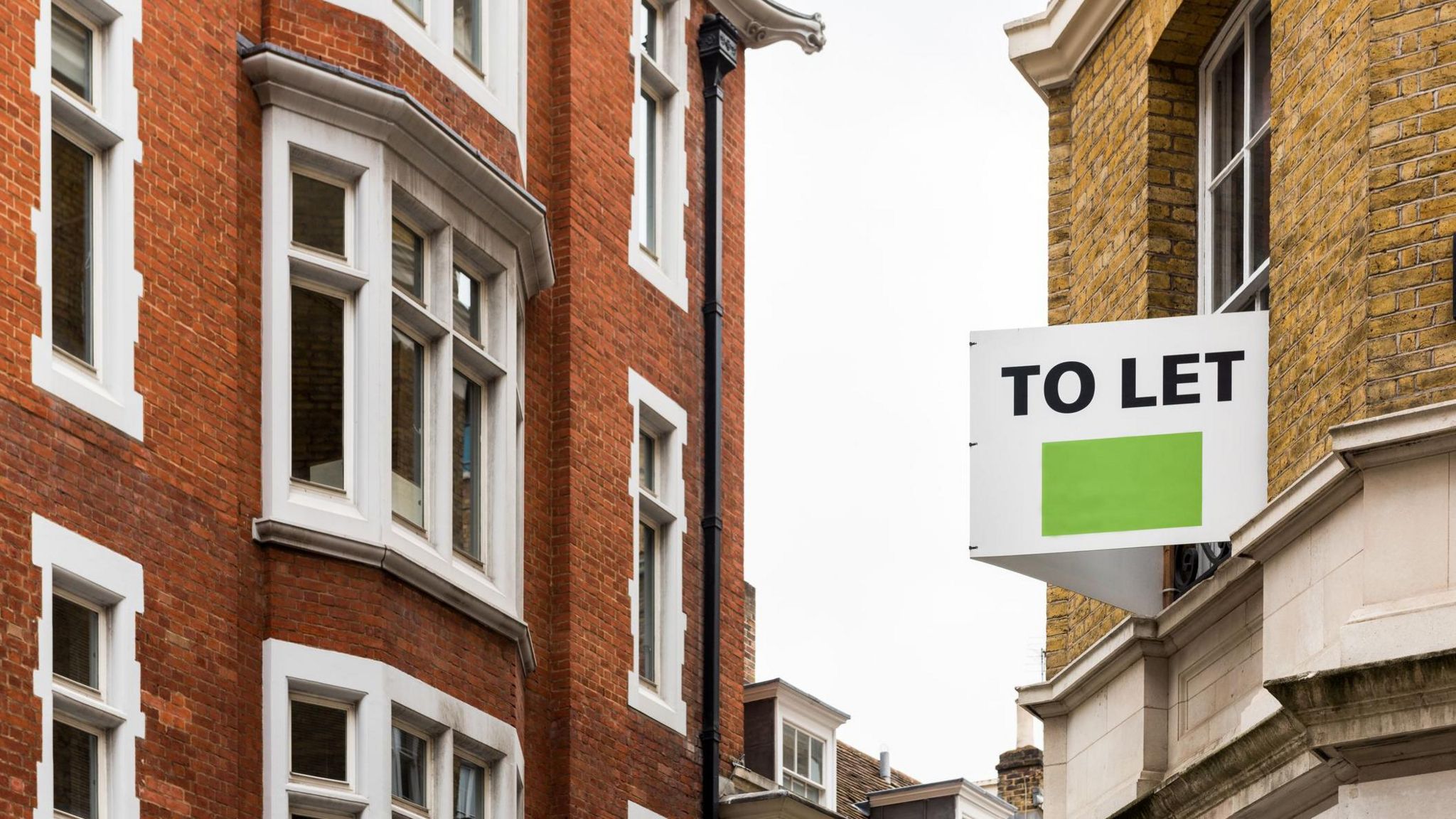 A "to let" sign on a property for rent in a London street.