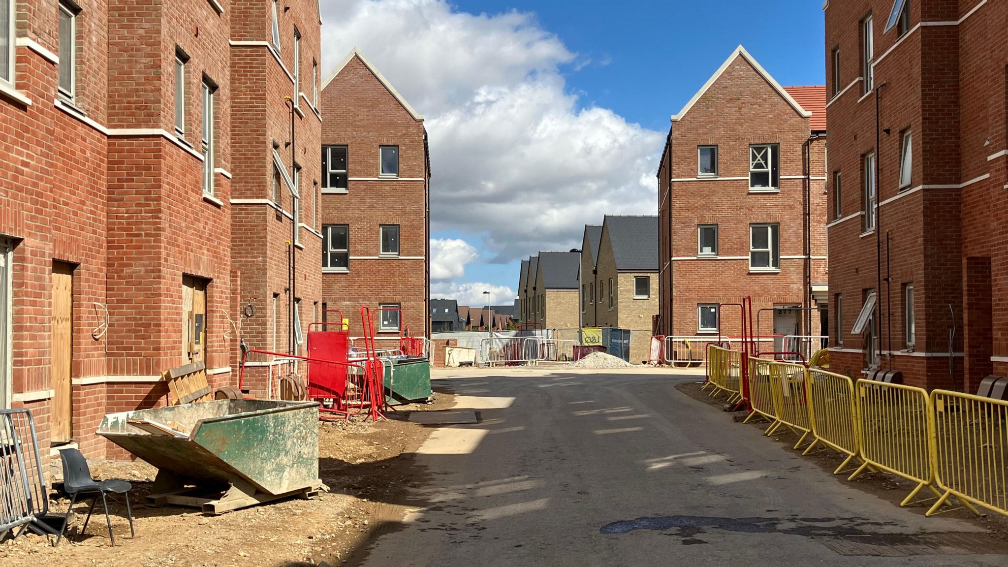 A view looking at homes and flats either side of a makeshift road on the Beaulieu Park estate in Chelmsford