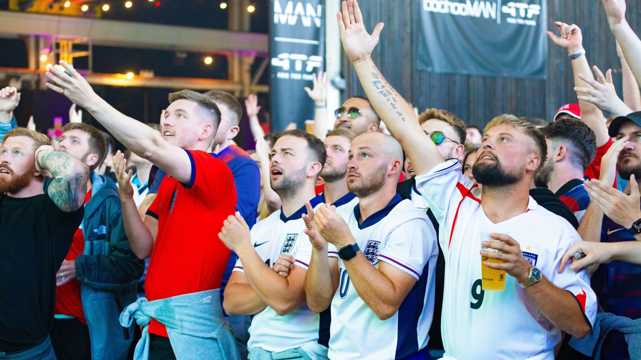 Fans watch England play in the Euros on a big screen