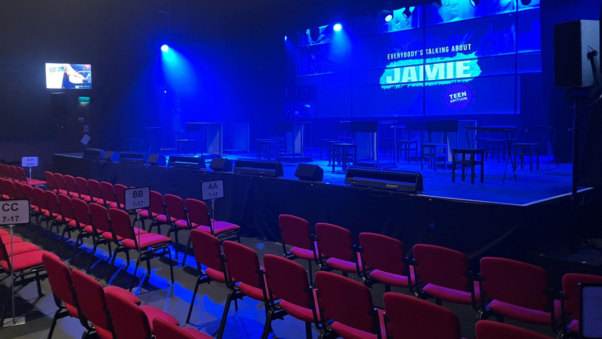 Red seats in rows in front of the stage at the Forum Theatre in Romiley