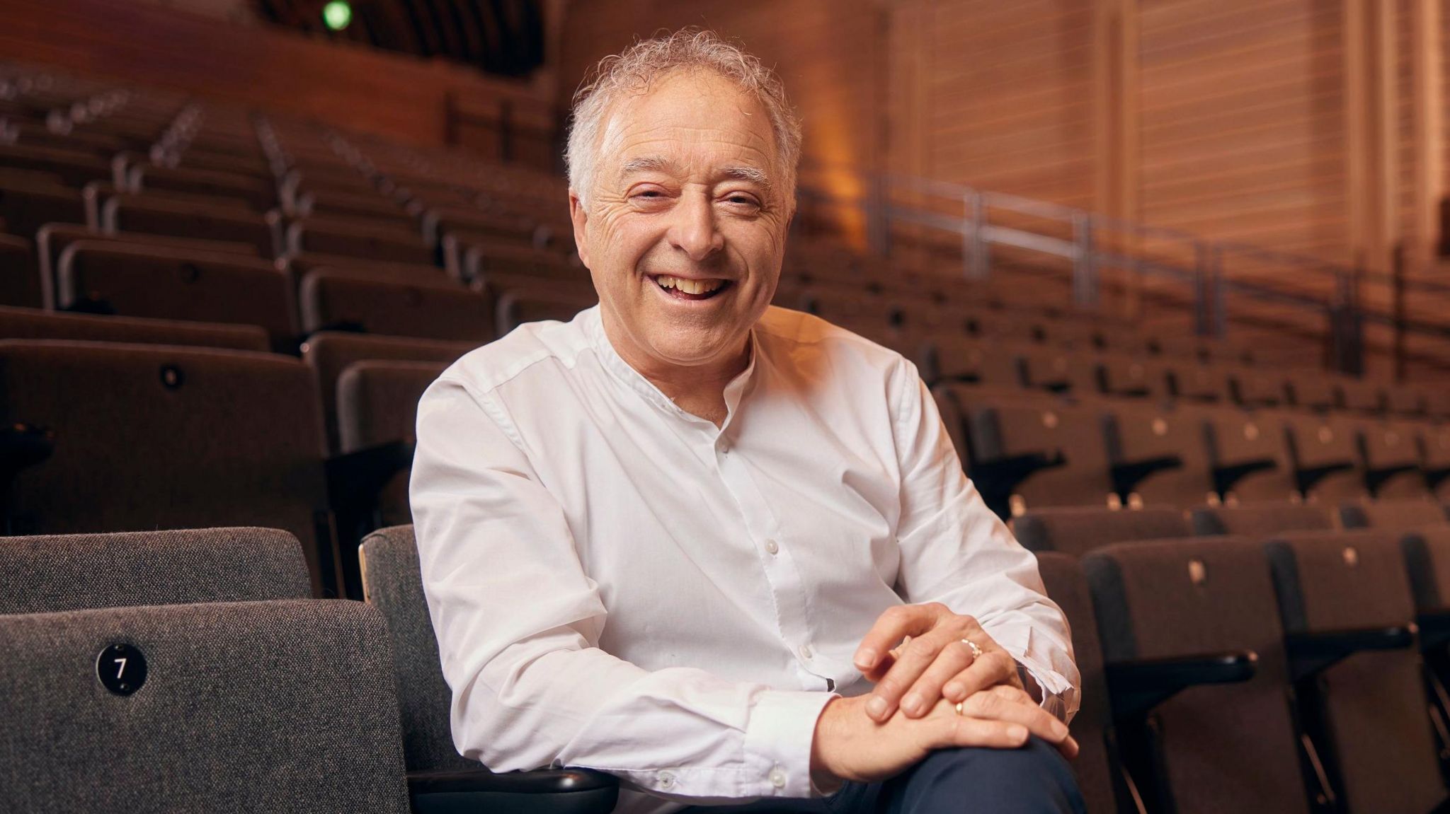 Frank Cottrell-Boyce sits in an arts venue