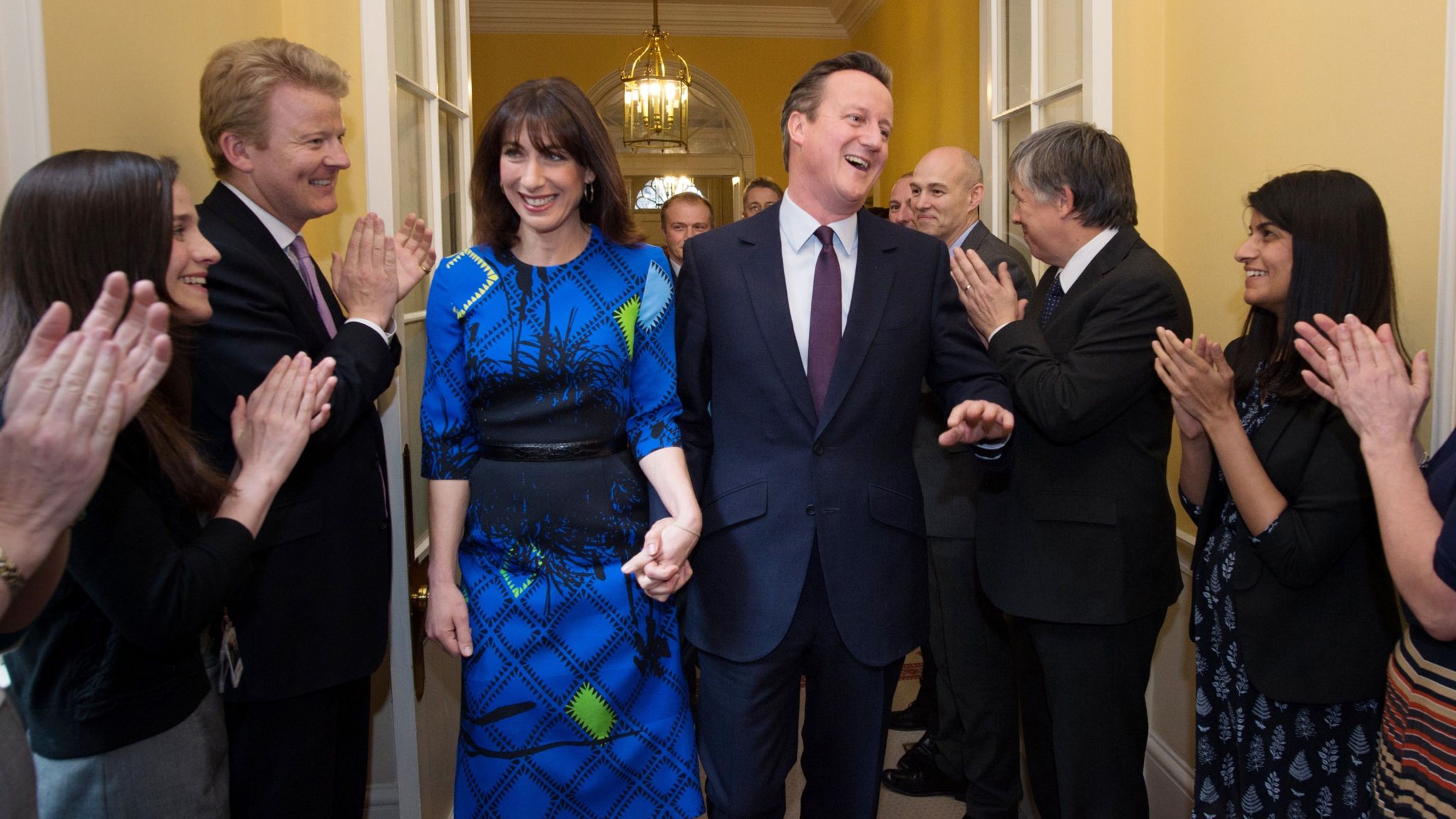David Cameron and wife Samantha are applauded upon entering Downing Street 