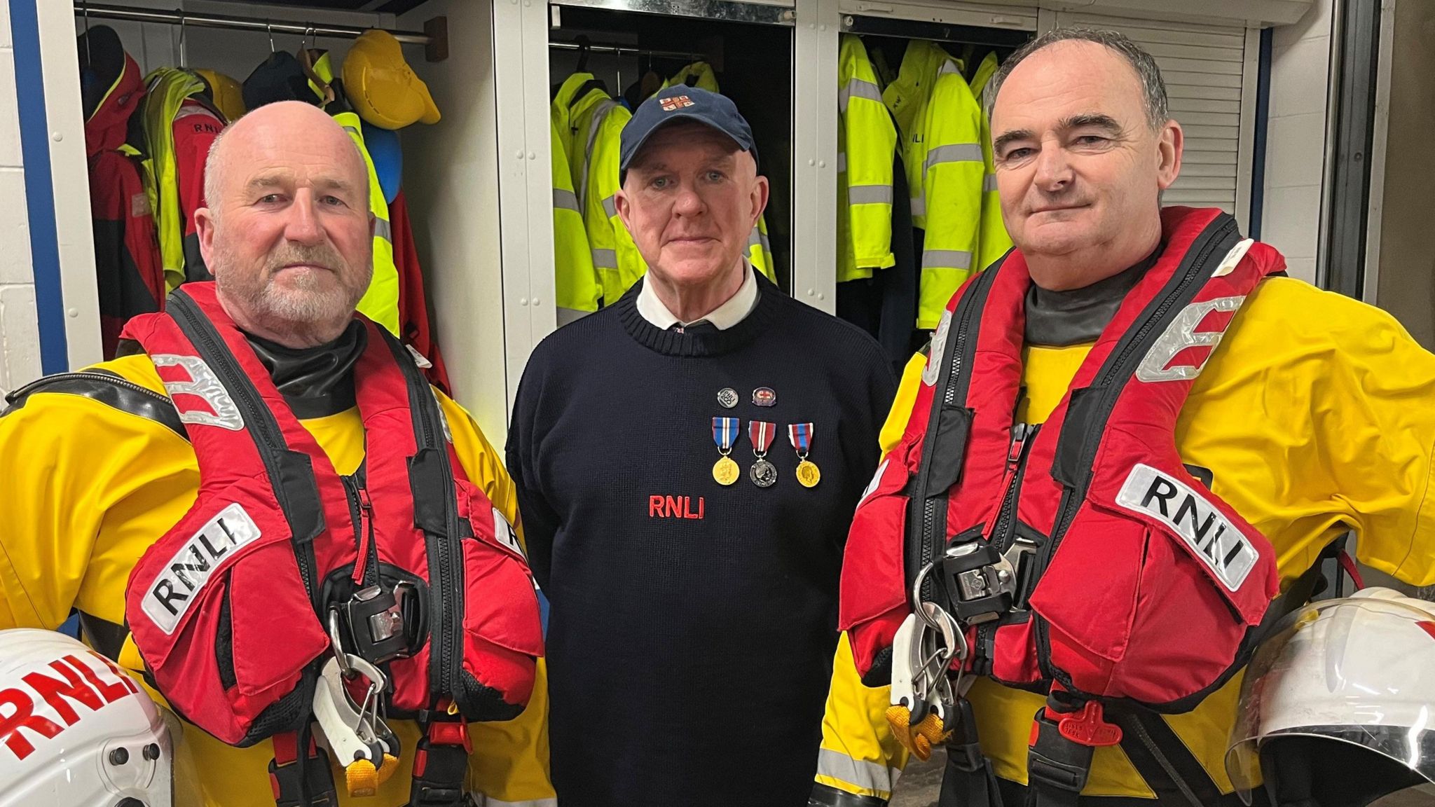 RNLI volunteers in boathouse wearing lifejackets