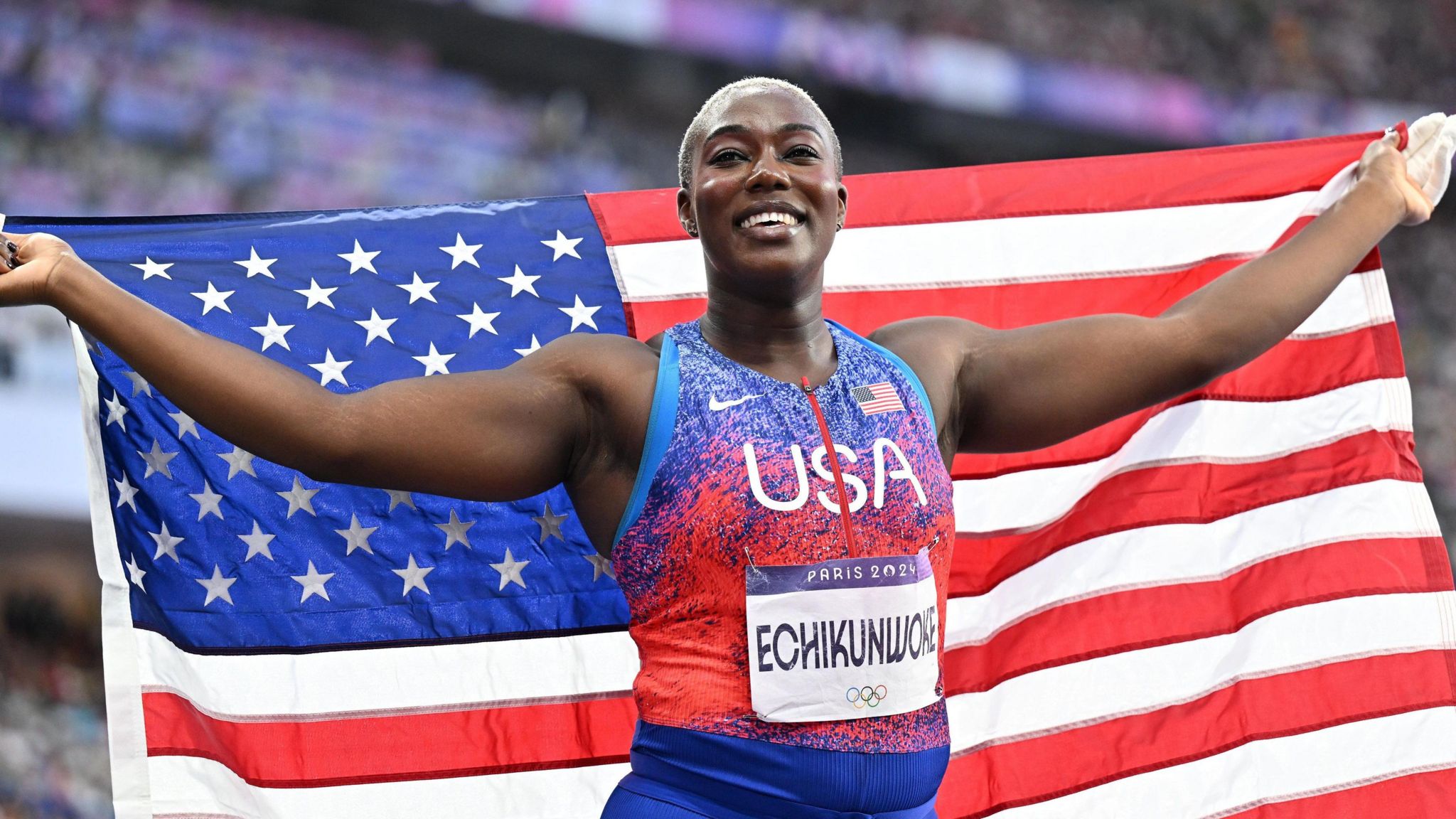 Annette Echikunwoke with an American flag