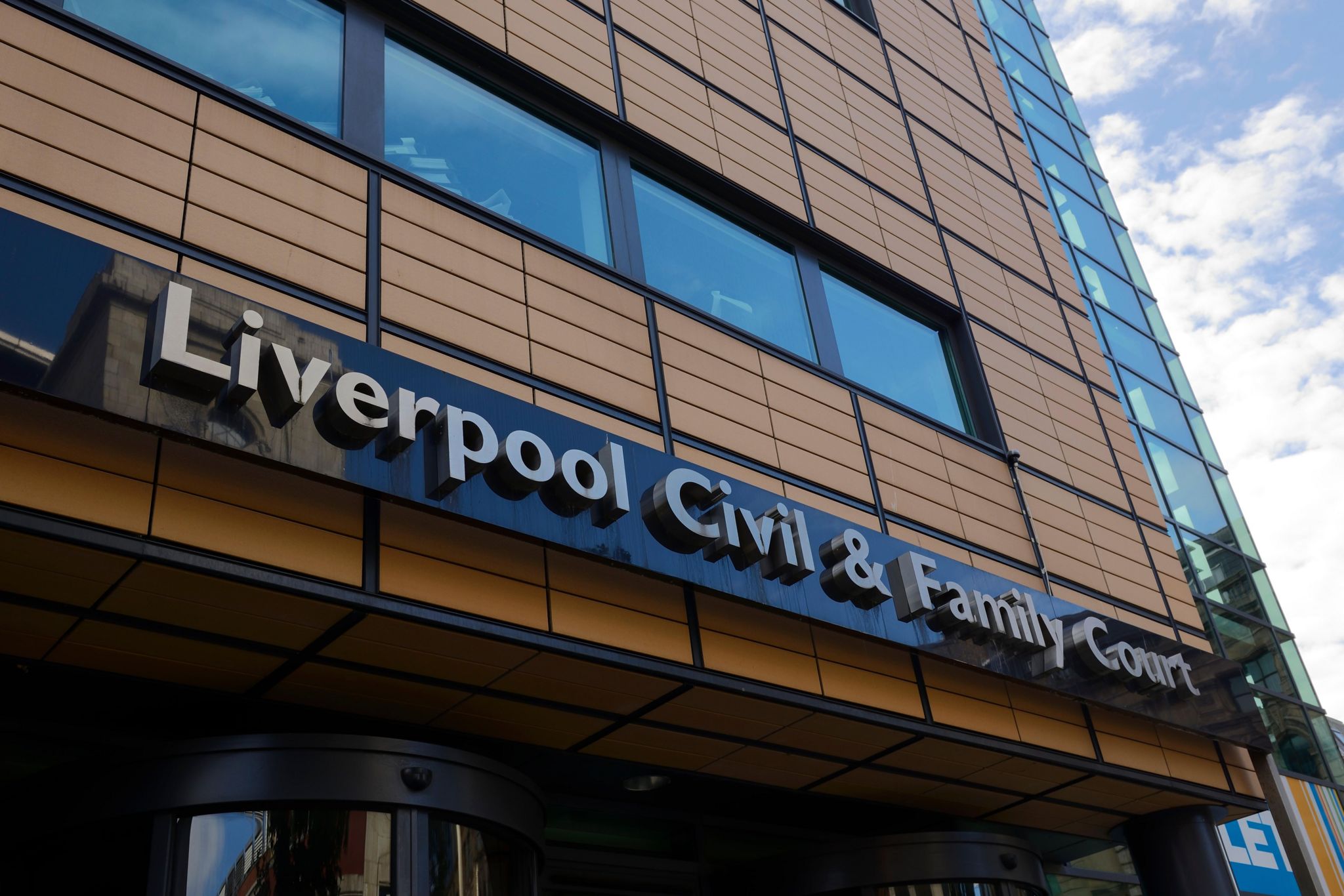 A tall brown building with the lettering "Liverpool Civil & Family Court"