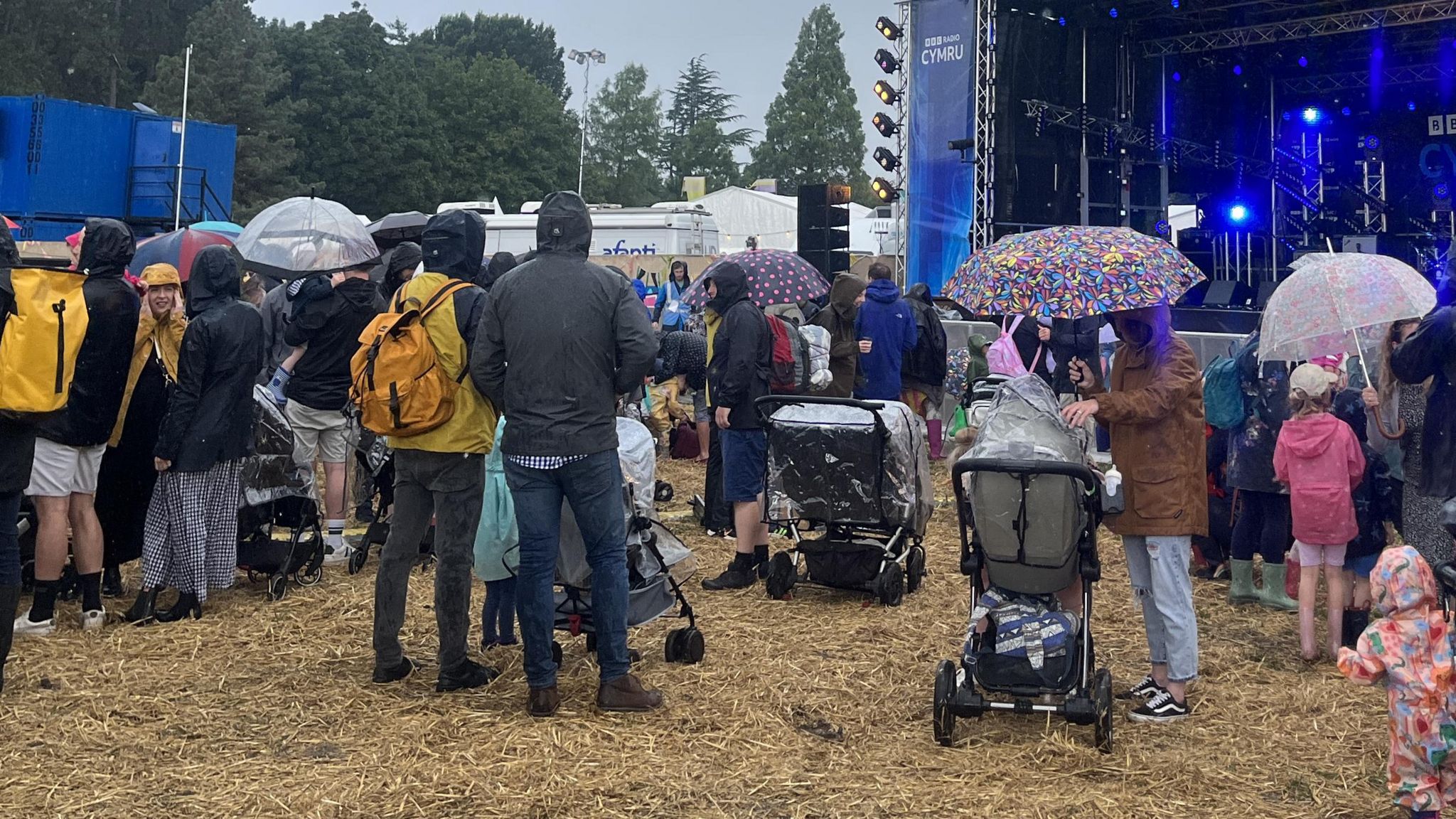 Crowd of spectators in raincoats