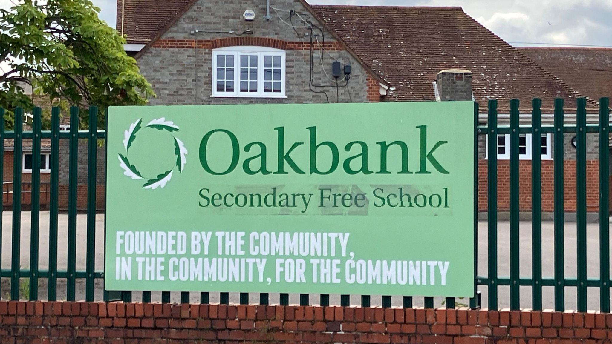 Oakbank Secondary School sign which says: Founded by the community, in the community, for the community