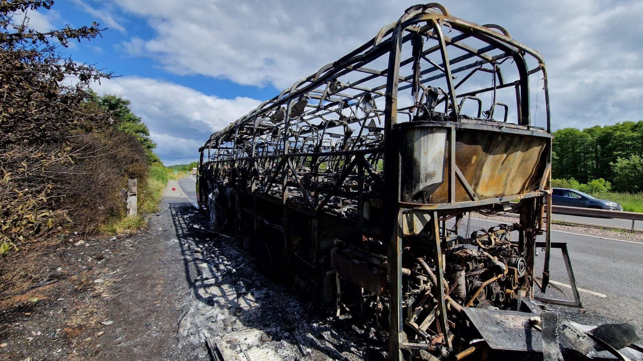 The gutted shell of a coach after a fire