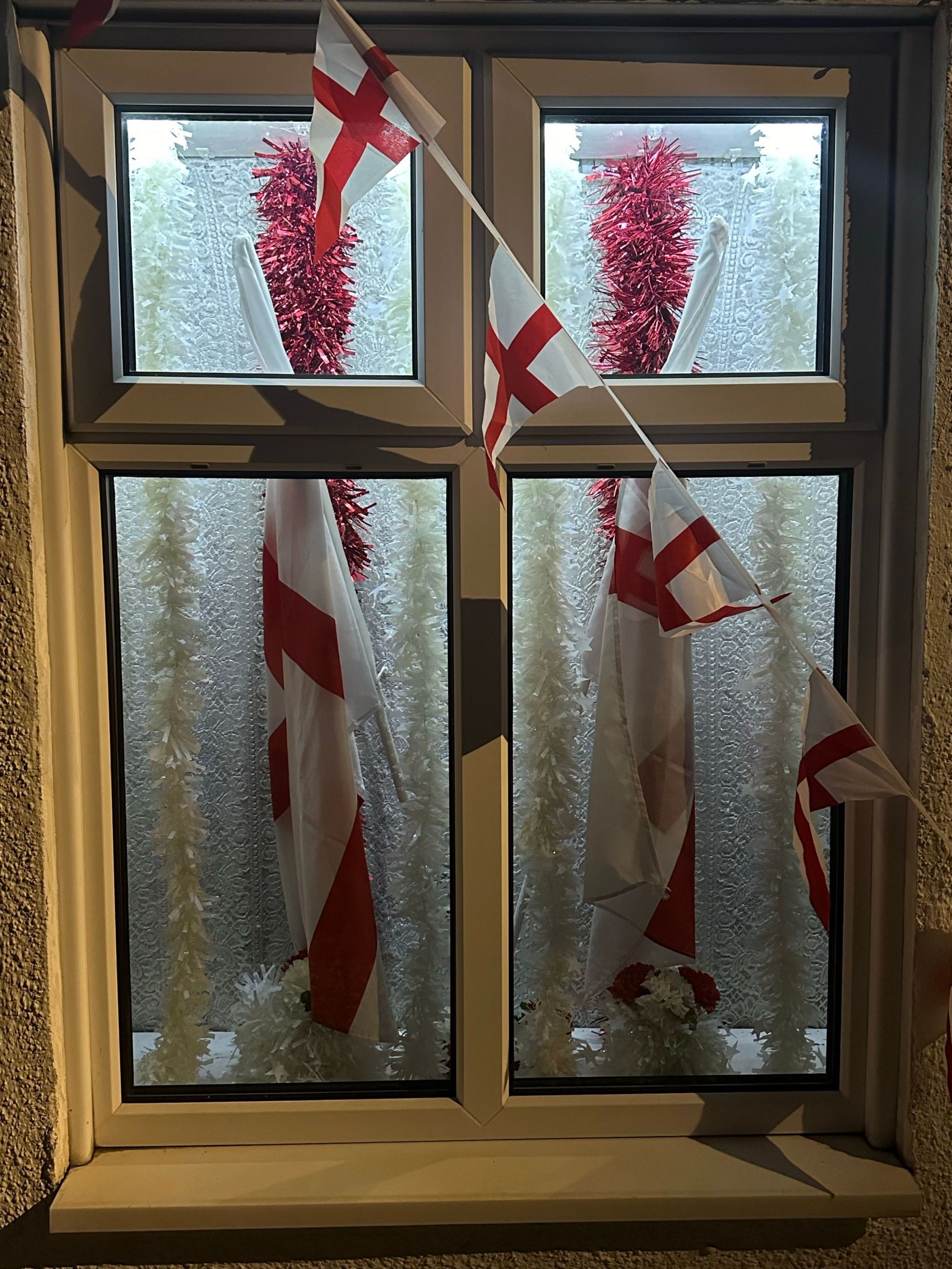 Windows have been decorated in flags and tinsel 