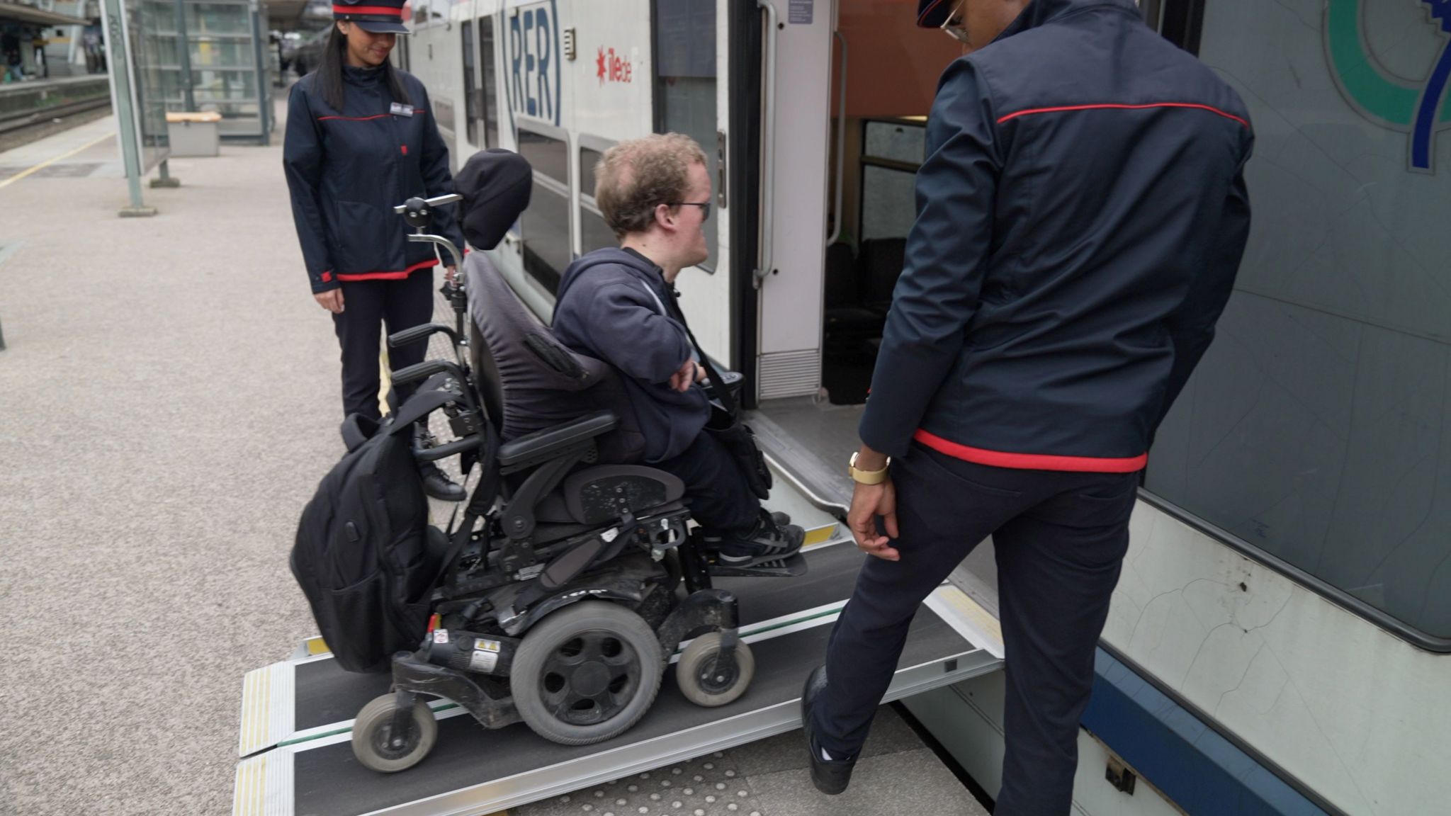 Mr Caffin uses a ramp to get on to a train at Maisons-Laffitte station