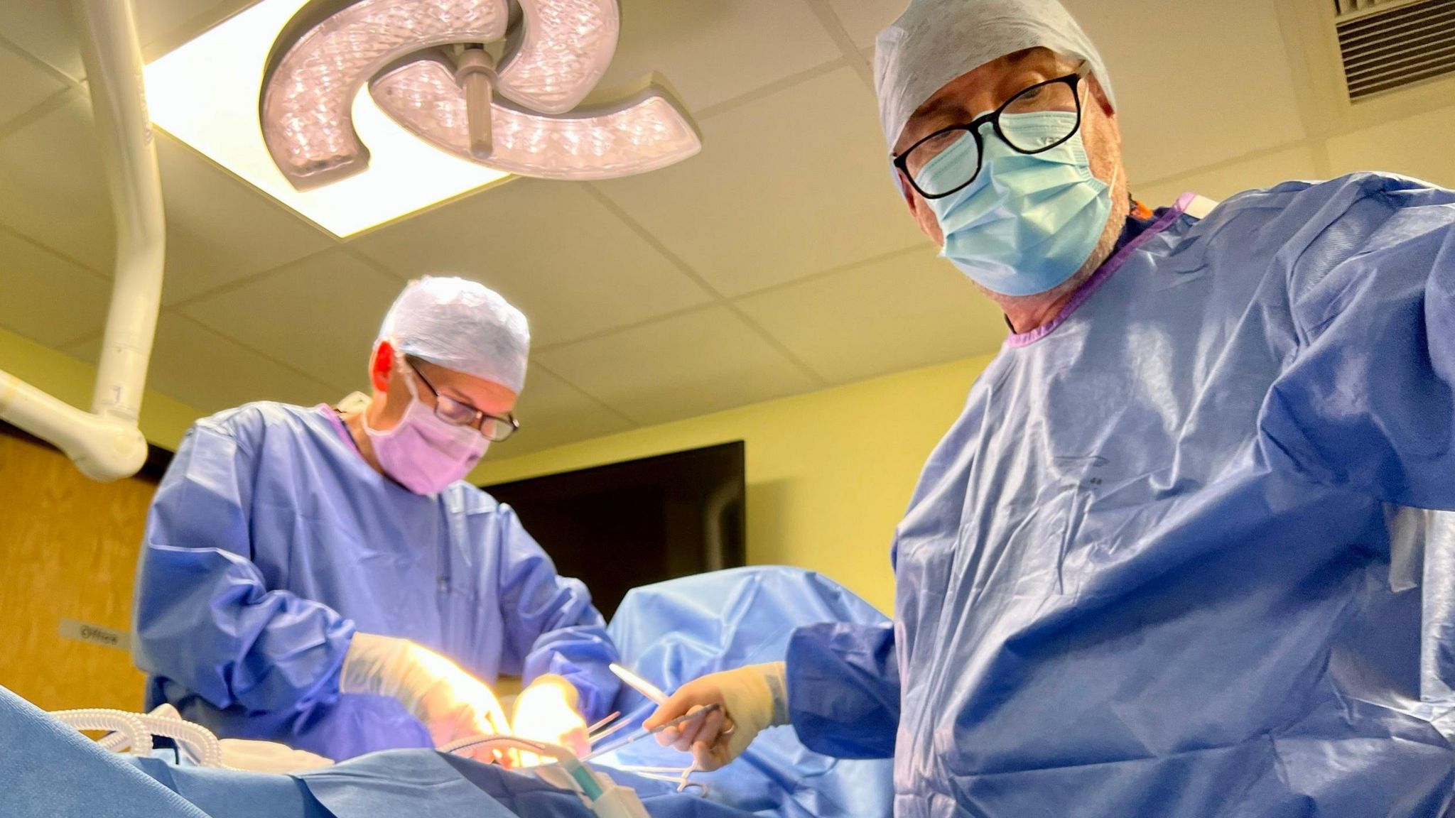 Surgeons operating on a patient at St Stephen's Gate Medical Practice