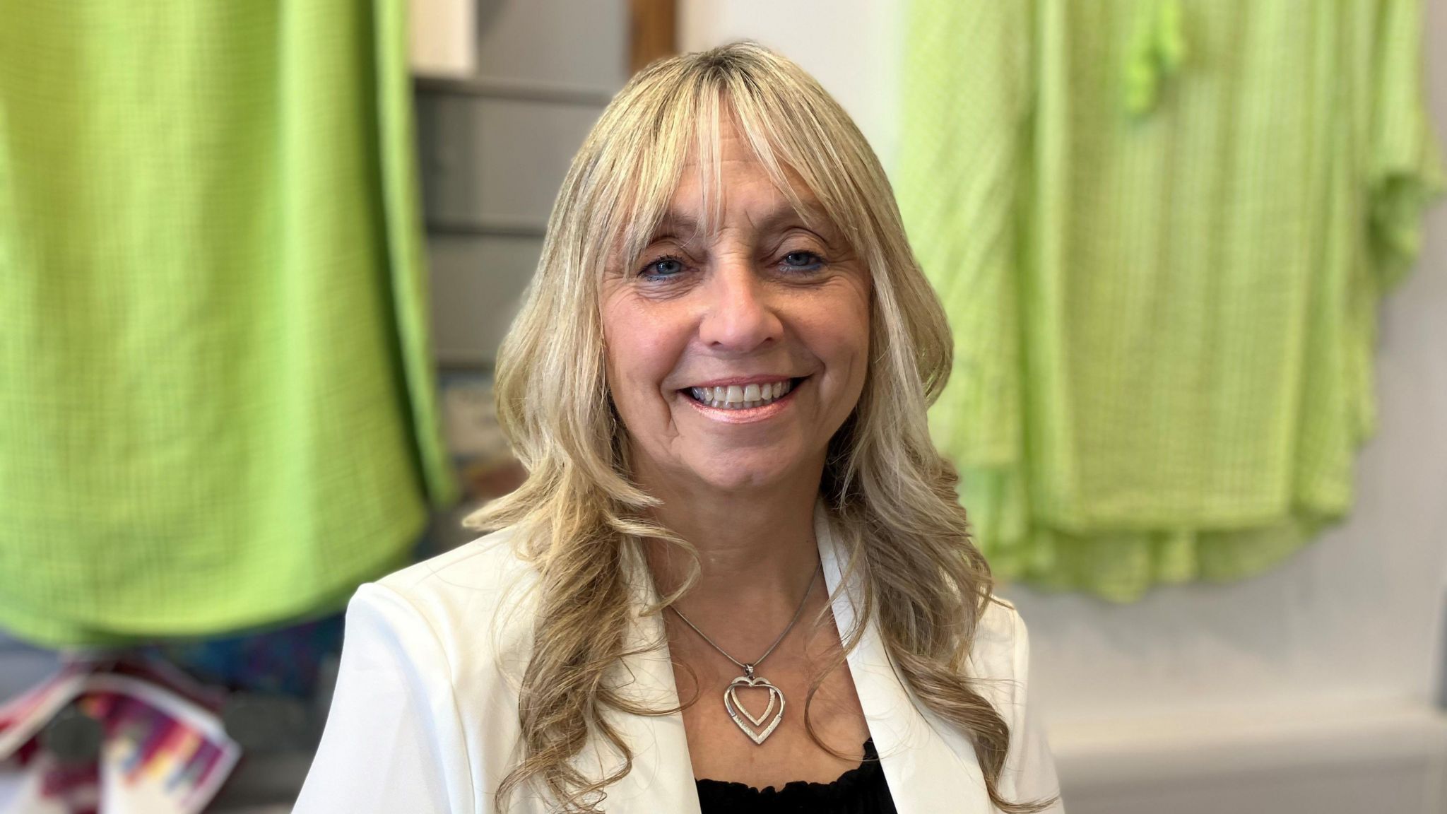 Carole Collier smiling at the camera in a shop